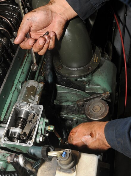 Senior Airman Ricardo Perez, 2nd Maintenance Squadron Aerospace Ground Equipment, fixes a diesel generator on Barksdale Air Force Base, La., April 29, 2014. If the diesel generator is not functioning properly it will send the incorrect input to the aircraft and the engine will not start. (U.S. Air Force photo/Senior Airman Kristin High) 