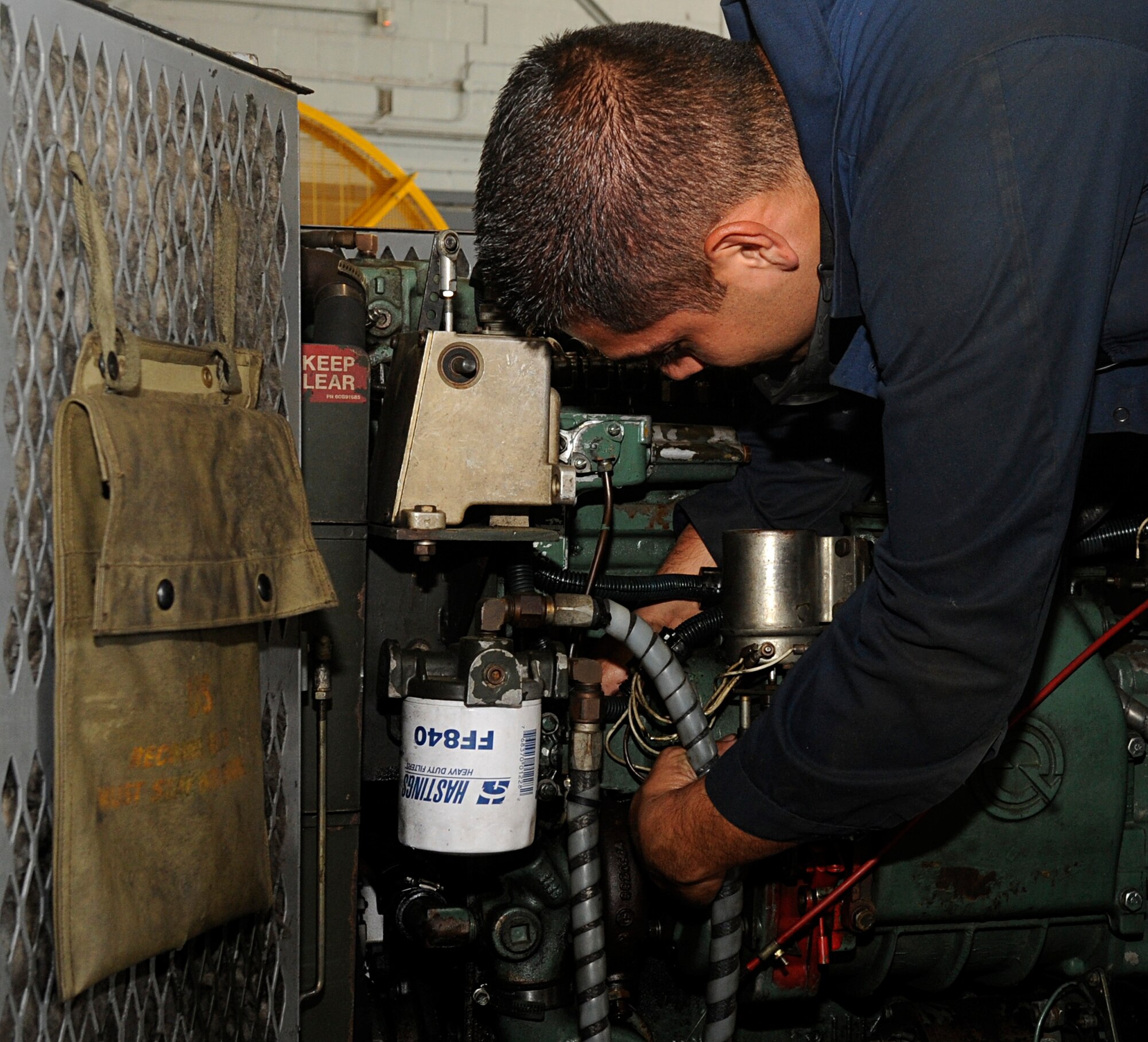 Senior Airman Ricardo Perez, 2nd Maintenance Squadron Aerospace Ground Equipment, changes the governor on a diesel generator on Barksdale Air Force Base, La., April 29, 2014. The generator helps to power the B-52H Stratofortress before take-off. (U.S. Air Force photo/Senior Airman Kristin High)