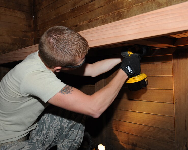 Staff Sgt. Cody Wiley, 2nd Civil Engineer Squadron Structures section, anchors a bench to a wall for a sauna at the Senior Airman Bryan R. Bell Fitness Center on Barksdale Air Force Base, La., April 29, 2014. The structures section's responsibilities include roof repairs, replacing doors and glass, metal working, masonry and carpentry. (U.S. Air Force photo/Senior Airman Benjamin Gonsier)