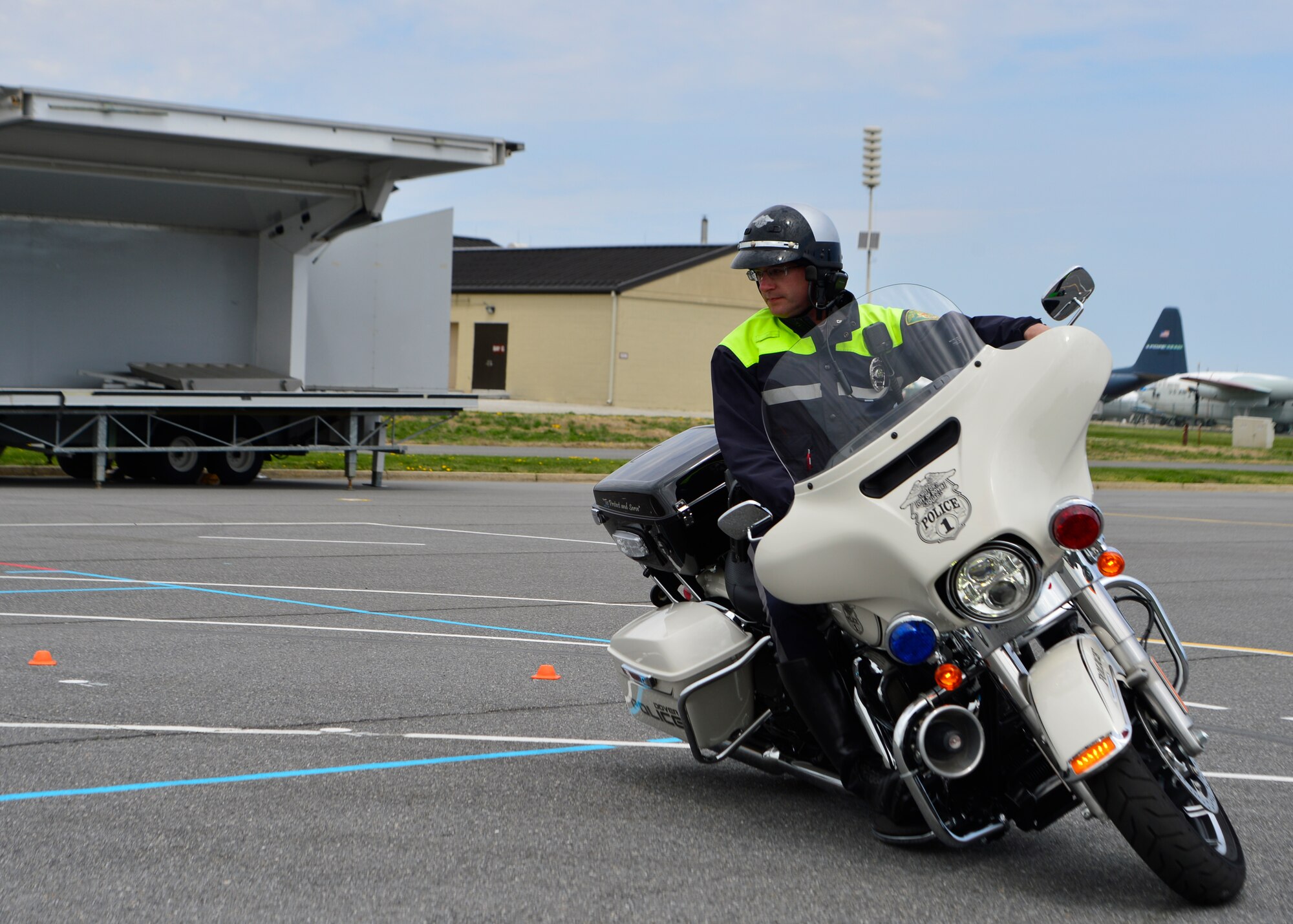 Cpl. Jason Pfeiffer, Dover Police Department special enforcement unit motor officer, rides through a slow speed control exercise April 25, 2014, at the Motorcycle Safety Day event on Dover Air Force Base, Del. The goal of the course is to maneuver around two 20 foot circles without putting your feet down. (U.S. Air Force photo/Airman 1st Class  William Johnson)