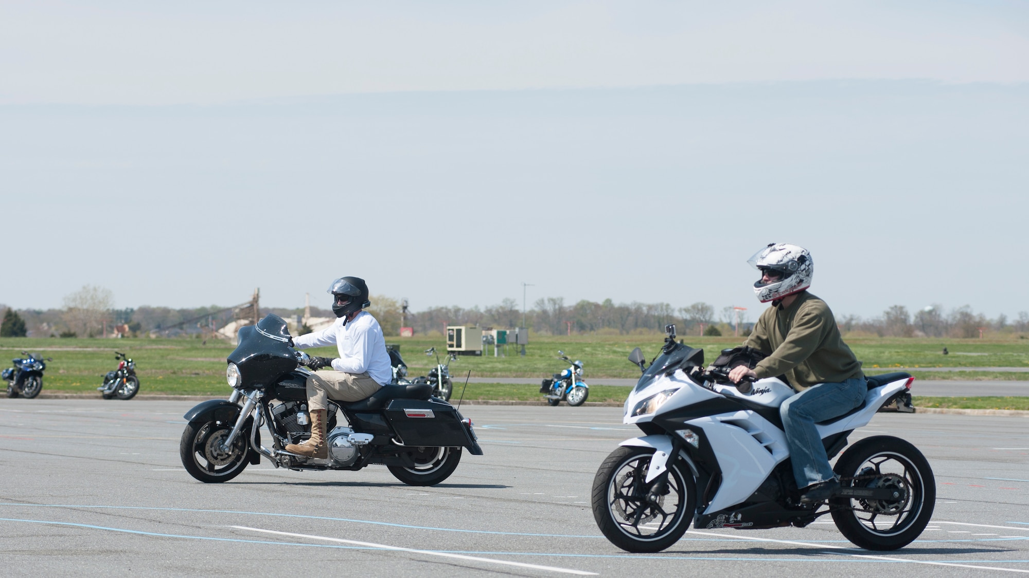 Two riders compete in a slow ride competition on Motorcycle Safety Day April 25, 2014, on Dover Air Force Base, Del.  The 9th annual Motorcycle Safety Day promoted safe motorcycle practices, accomplished a yearly training requirement and fostered camaraderie among riders. (U.S. Air Force photo/Senior Airman Jared Duhon)