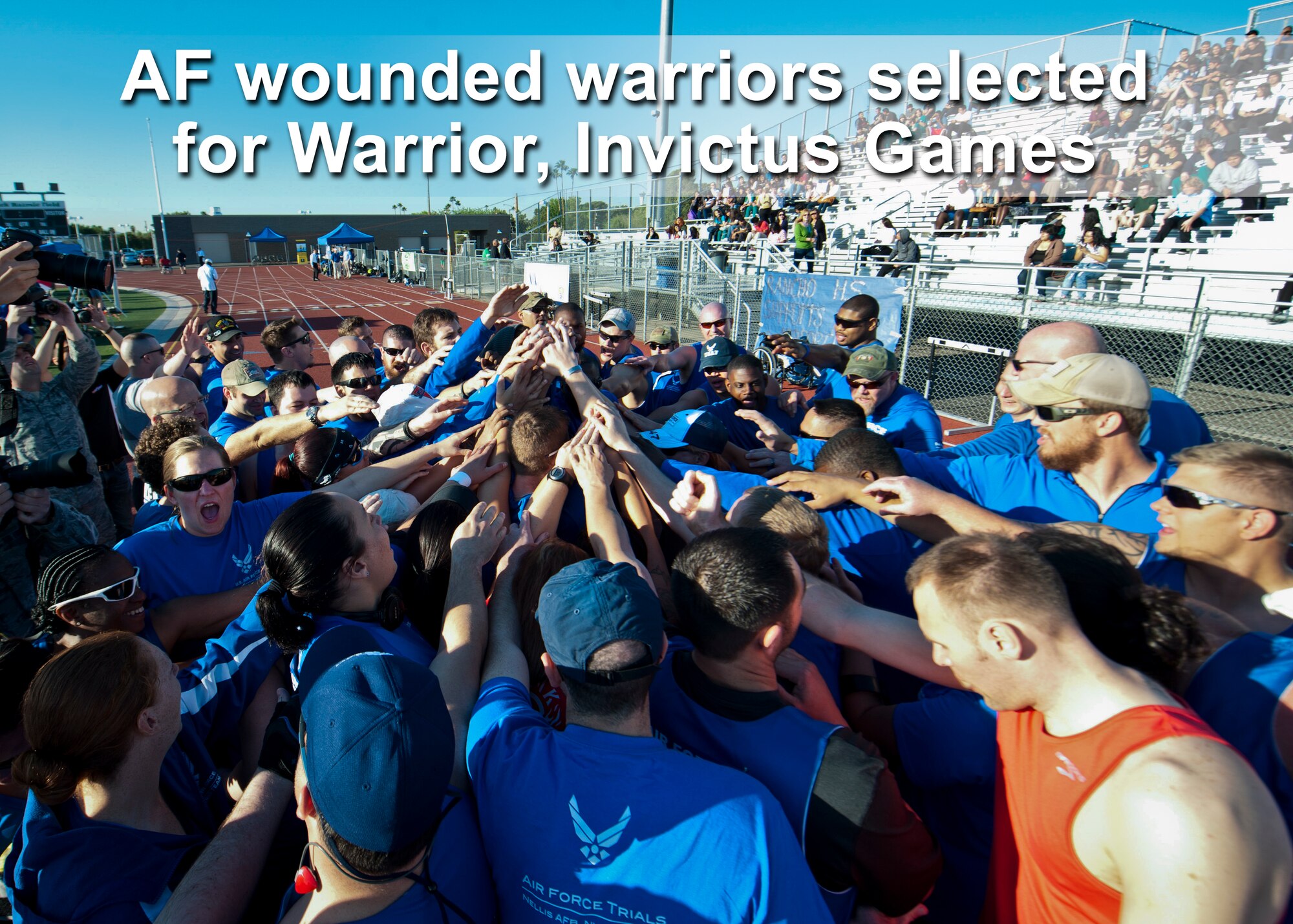 Wounded Warrior athletes huddle up for motivation and camaraderie before the track and field portion of the Air Force Wounded Warrior Team Trials April 8, 2014, at Rancho High School, Las Vegas. Adaptive athletic reconditioning helps wounded warriors build strength and endurance, while they draw inspiration from their team mates. (U.S. Air Force photo by Airman 1st Class Thomas Spangler)