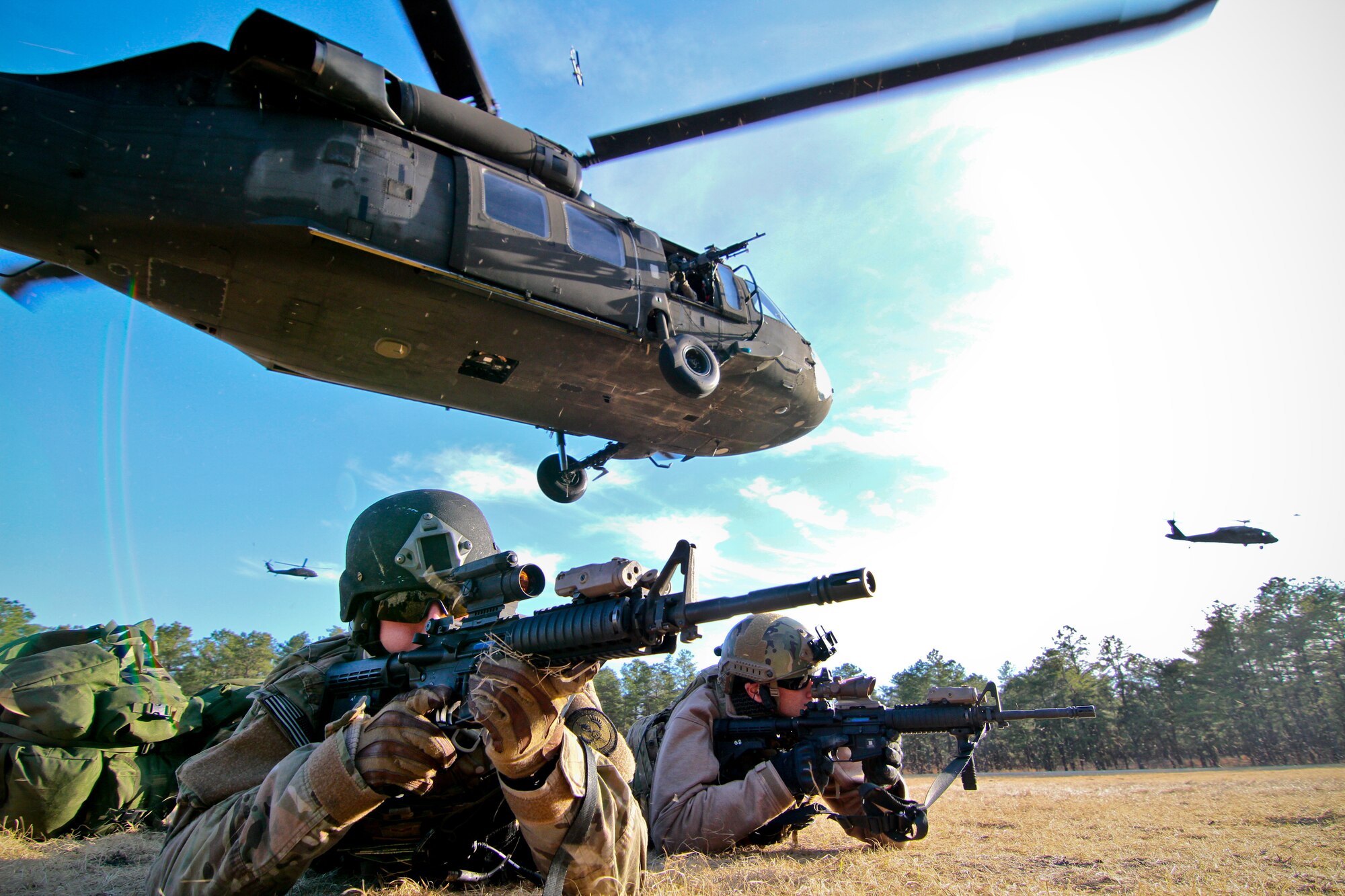 Senior Airman Sean Meehan, left, and Staff Sgt. Kane Lawlor provide cover after a tactical air insertion with an Army UH-60 Black Hawk helicopter April 10, 2014, at Joint Base McGuire-Dix-Lakehurst, N.J. The New Jersey National Guard participated in a joint training exercise with the Marine Corps. Meehan and Lawlor are tactical air control party specialists with the 227th Air Support Operations Squadron, New Jersey Air National Guard. The helicopter is assigned to the 1st Battalion, 150th Aviation Regiment, New Jersey Army National Guard. (U.S. Air National Guard photo/Tech. Sgt. Matt Hecht)