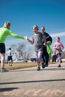 Family members and friends standing along the sidelines reach out to give high-fives to Mighty Medic Meltdown Run participants at Minot Air Force Base, N.D., April 25, 2014. This event was hosted by the 5th Medical Group to raise awareness for child abuse and sexual assault prevention. (U.S. Air Force photo/Airman 1st Class Sahara L. Fales)
