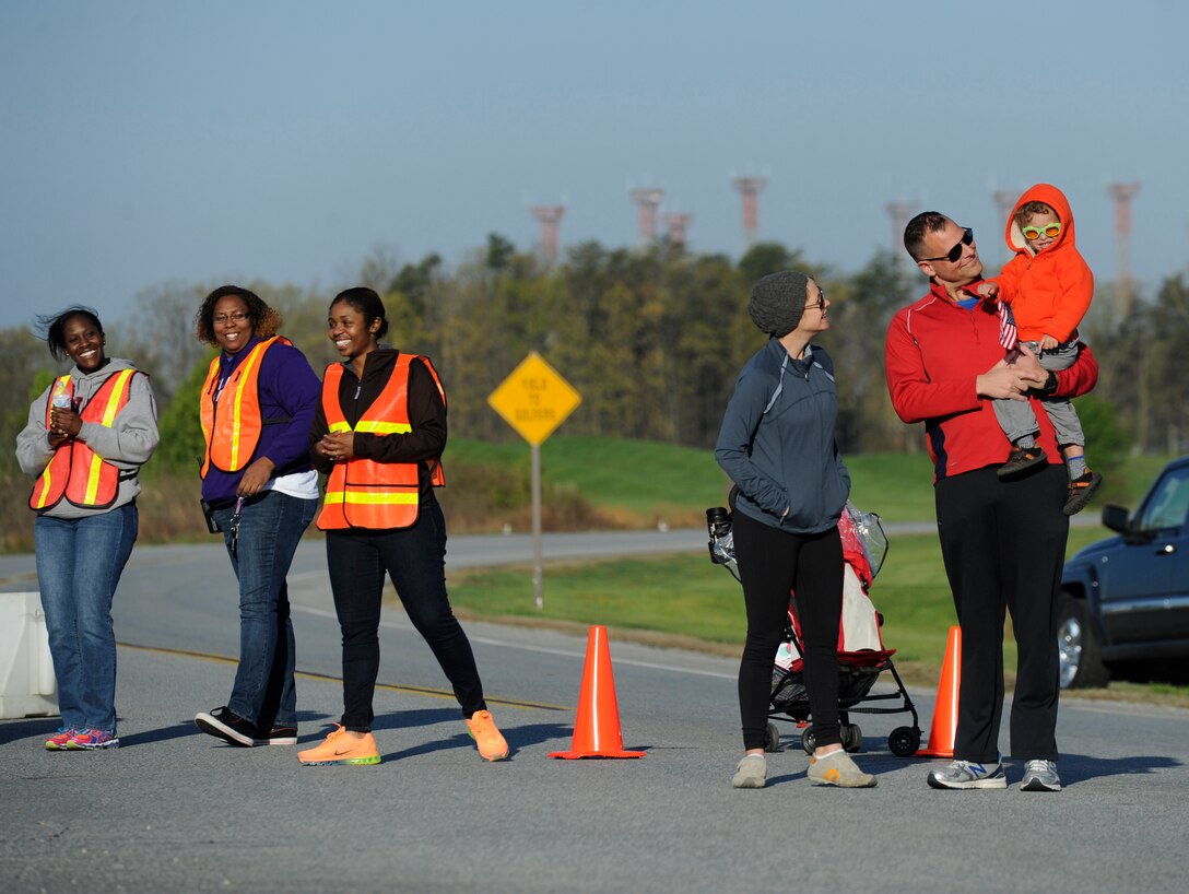 Joint Base Andrews Half Marathon supporters and volunteers cheer on runners at the half-way point, April 26, 2014. The race was organized by the Andrews Chief’s Group to promote unity between various units and services. (U.S. Air Force photo/Senior Airman Nesha Humes)

