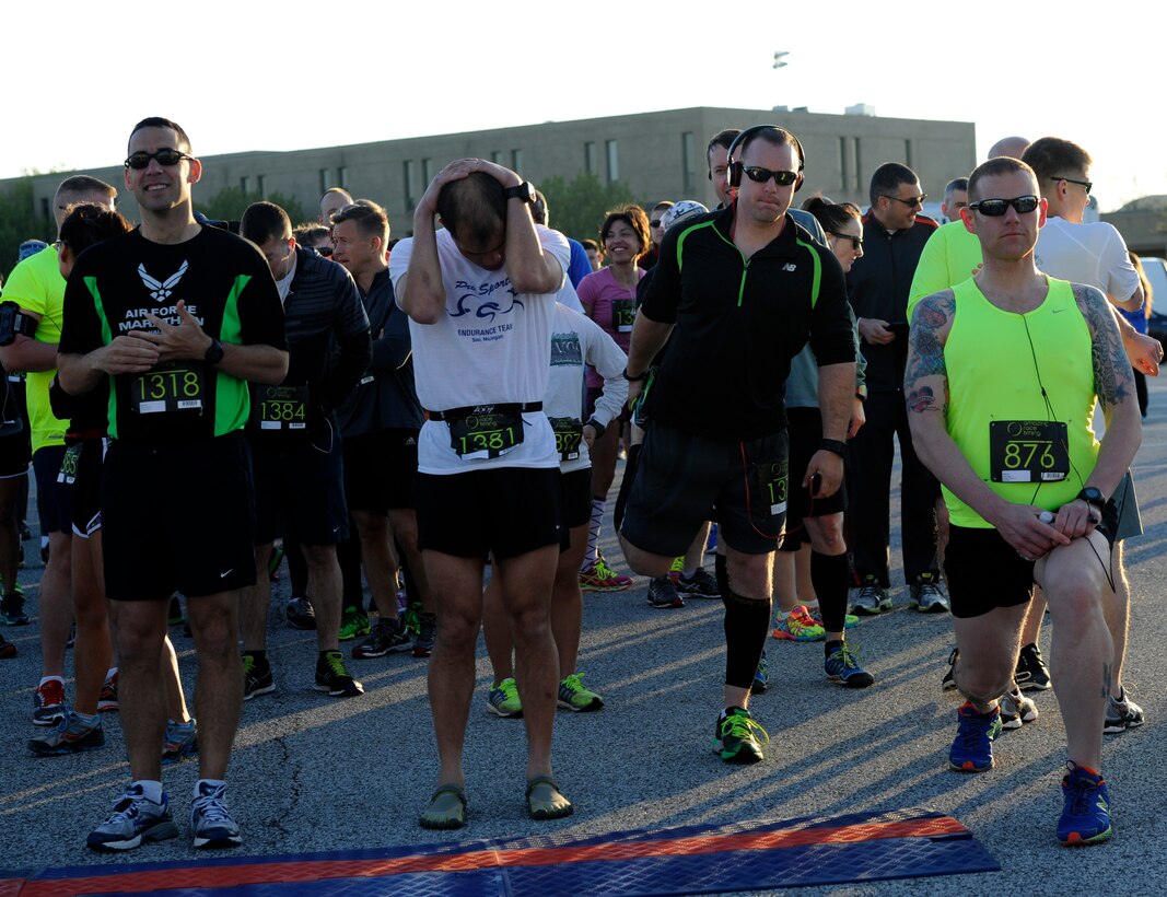 Runners stretch at the start line to prepare for the Joint Base Andrews Half Marathon here April 26, 2014. Participants represented every military branch in the National Capital Region including enlisted, officer and civilian. (U.S. Air Force photo/Senior Airman Nesha Humes)
