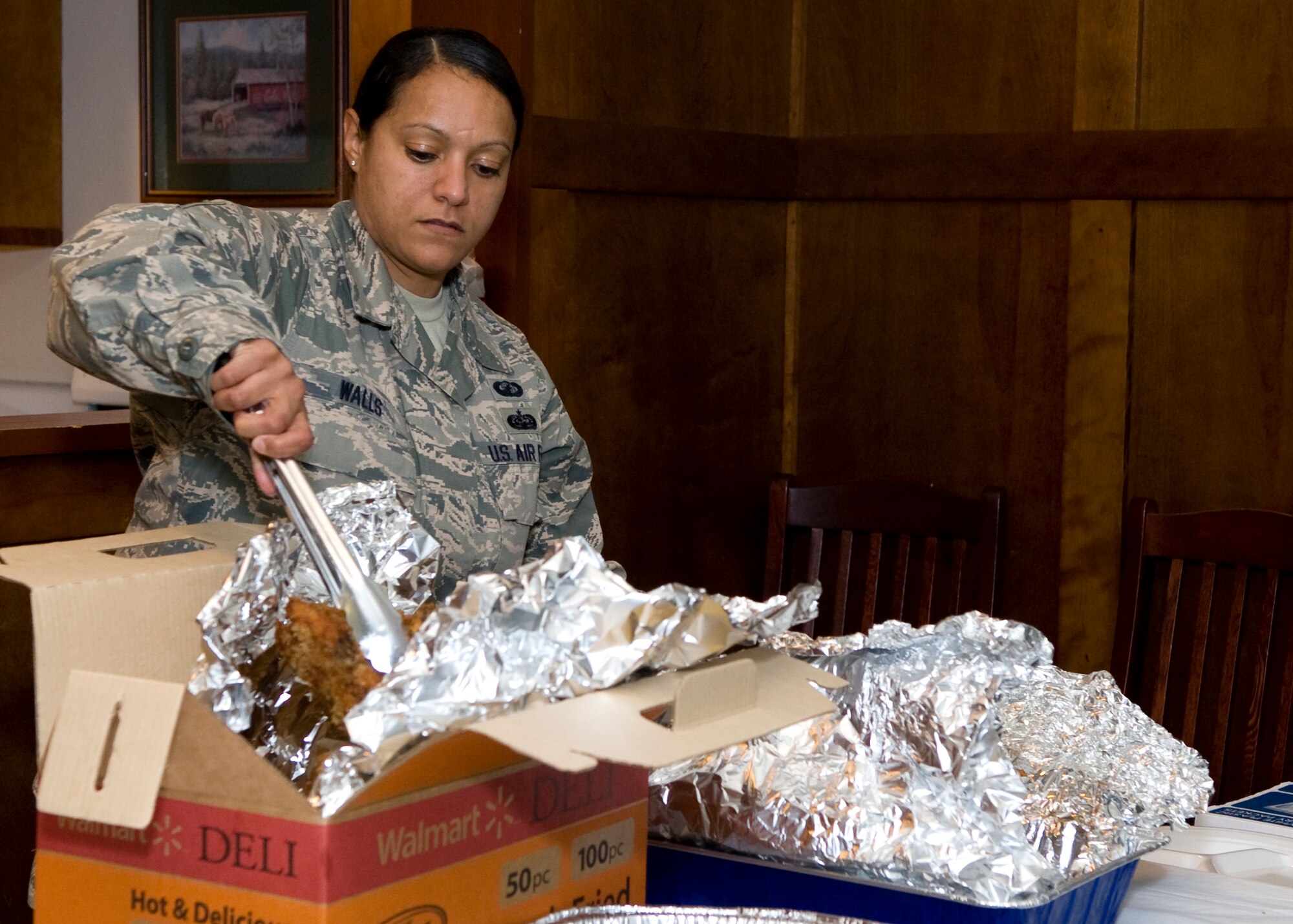 Master Sgt. Anita Walls, 436th Contracting Squadron NCO in charge of base operations, serves food at the Spring Dorm Dinner April 24, 2014, inside the Eagle’s Net Café on Dover Air Force Base, Del. Walls, a member of the Top 3 Organization, volunteered to help host the event. (U.S. Air Force photo/Airman 1st Class Zachary Cacicia)