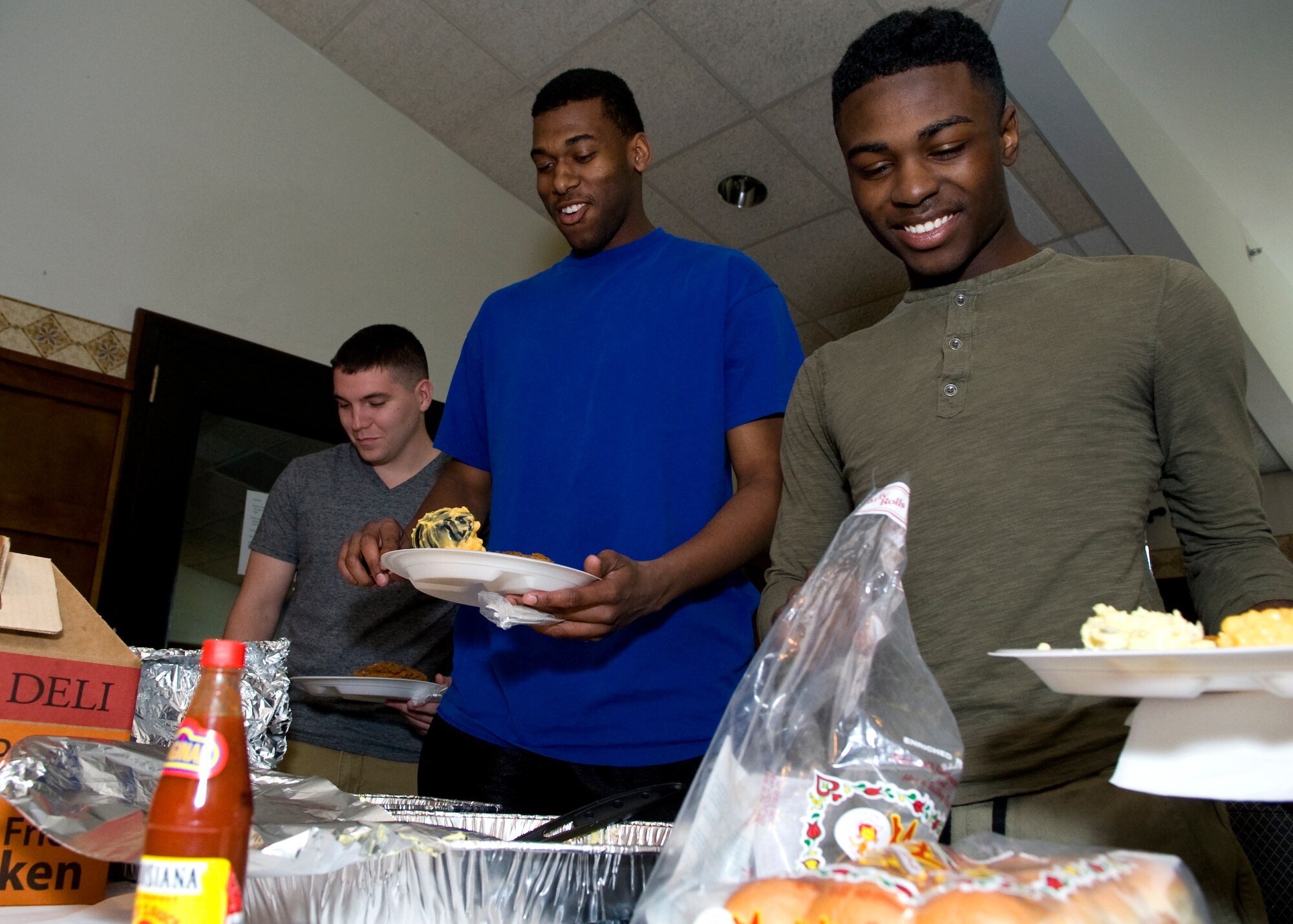 Airman Derrick Harris, 436th Logistics Readiness Squadron fuels operator, right, Airman 1st Class Devante Williams, 436th LRS material management, center, and Airman 1st Class Joshua Floyd, 436th Security Forces raven, help themselves to food at the Spring Dorm Dinner April 24, 2014, inside the Eagle’s Net Café on Dover Air Force Base, Del. The dinner was hosted by the Dover AFB chapel and the Top 3. (U.S. Air Force photo/Airman 1st Class Zachary Cacicia)