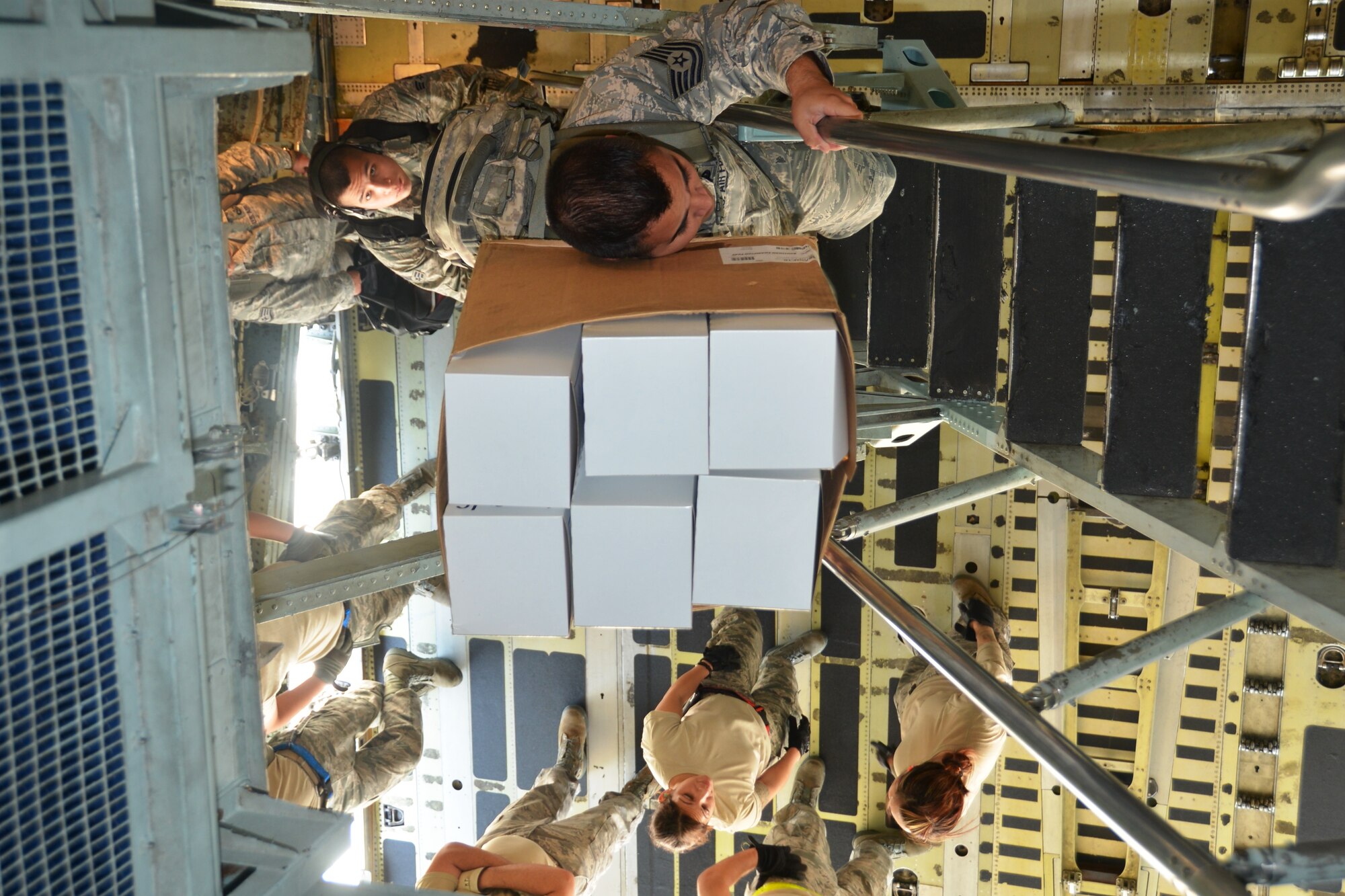 An Airman from the 433rd Airlift Control Flight carries a cardboard box of box lunches as he climbs the troop deck ladder of a C-5A Galaxy aircraft prior to taking off from Joint Base San Antonio-Lackland, Texas, 23 April, 2014 to participate in Air Force Reserve Command’s Patriot Hook Exercise at Naval Air Station, North Island, Calif. (U.S. Air Force photo/Senior Master Sgt. Minnie Jones)
