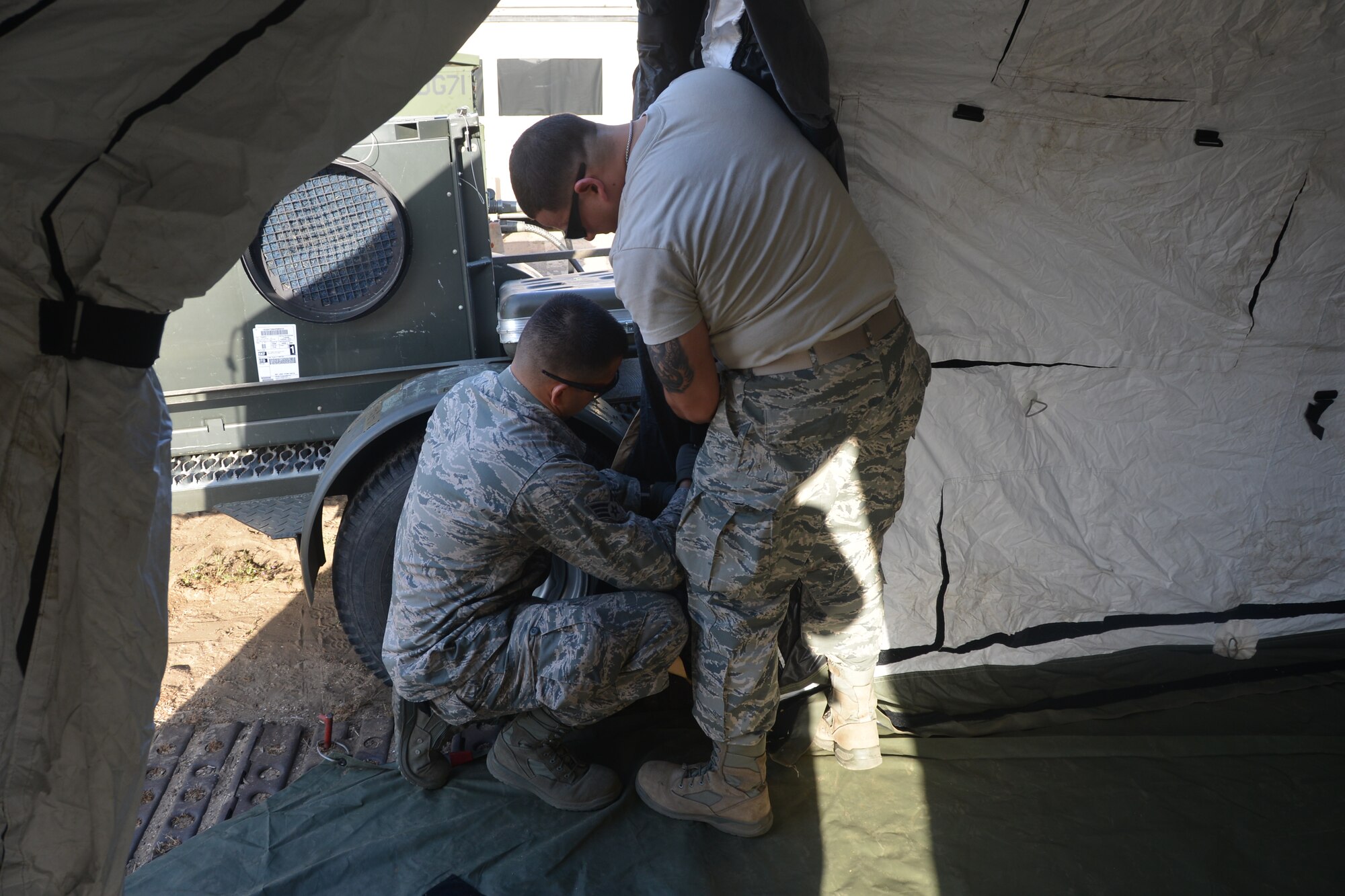 Airmen from the 433rd Airlift Wing, Joint Base San Antonio-Lackland, Texas erect posts for The Deployable Rapid Assembly Shelter, or DRASH tent, 24 April, 2014, Naval Air Station, North Island, Calif. A DRASH tent is a quick-erect tent system that integrates shelter, mobility, lighting, heating, cooling and energy efficient was used during the Air Force Reserve Command’s Patriot Hook Exercise.  Patriot Hook is an annual AFRC sponsored exercise that integrates federal agencies with the military, focusing on making the most of command and support, training, integration and practicing mobilizations to disasters and emergencies. (U.S. Air Force photo/Senior Master Sgt. Minnie Jones)



