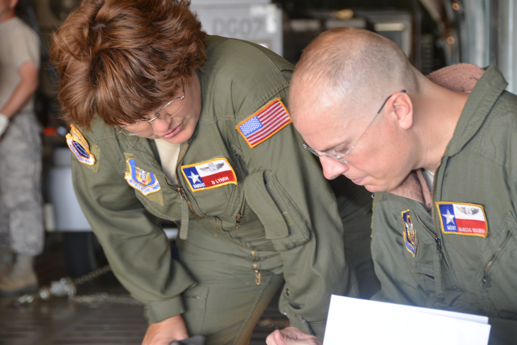 Loadmasters Senior Master Sgt. Denise Lynch, (left) 433rd Airlift Control Flight and Master Sgt. Marcus Wasden, 68th Airlift Squadron from Joint Base San Antonio-Lackland, Texas.  Review their load plan before departing JBSA-Lackland to Air Force Reserve Command’s Patriot Hook 2014 exercise at Naval Air Station, North Island, Calif., April 24, 2014. (U.S. Air Force photo/Senior Master Sgt. Minnie Jones)
