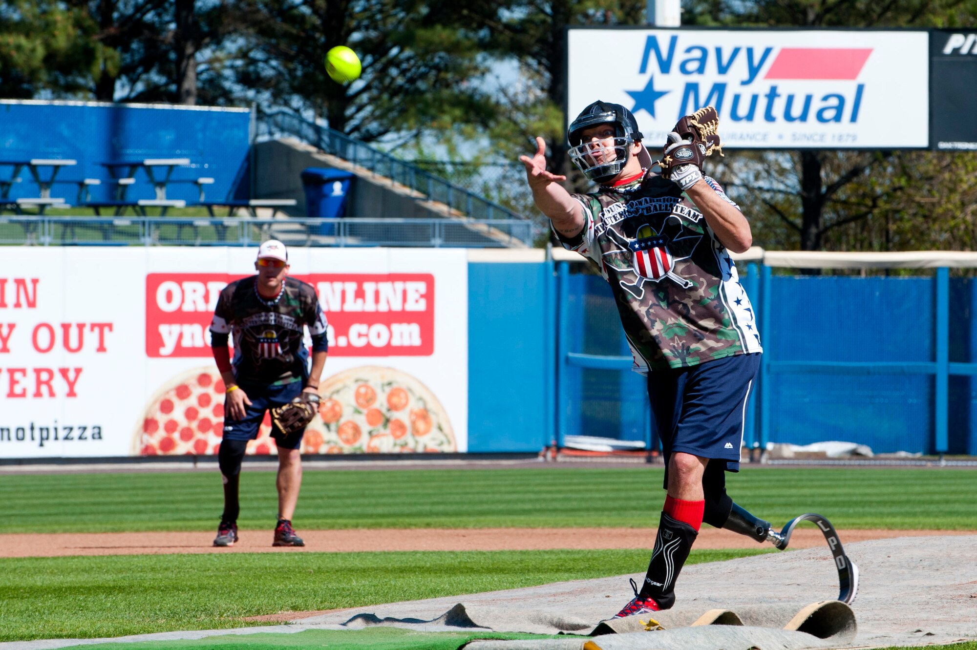 Mike Dreyer, a U.S. Air Force veteran and Wound Warrior Amputee Softball team player, throws a pitch during the 2nd annual Spartyka Wounded Warrior Softball Classic at Harbor Park in Norfolk, Va., April 26, 2014. The team’s goal is to show through extensive rehabilitation and training, anyone is able to carry on and perform the sport they love. (U.S. Air Force photo by Senior Airman R. Alex Durbin/Released)