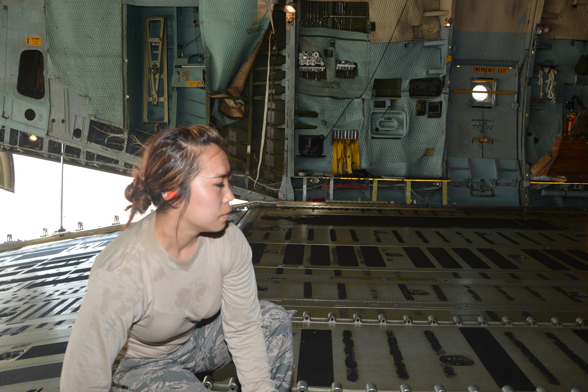 Aerial porter, Tech. Sgt. Sarah Benz, 26th Aerial Port Squadron, Joint Base San Antonio-Lackland, Texas, converts the floor of a C-5A Galaxy aircraft by turning over the rollerized conveyor system, so cargo can be rolled into the cargo bay of the aircraft for Air Force Reserve Command’s Patriot Hook 2014 exercise at Naval Air Station, North Island, Calif., 24 April, 2014. (U.S. Air Force photo/Senior Master Sgt. Minnie Jones)
