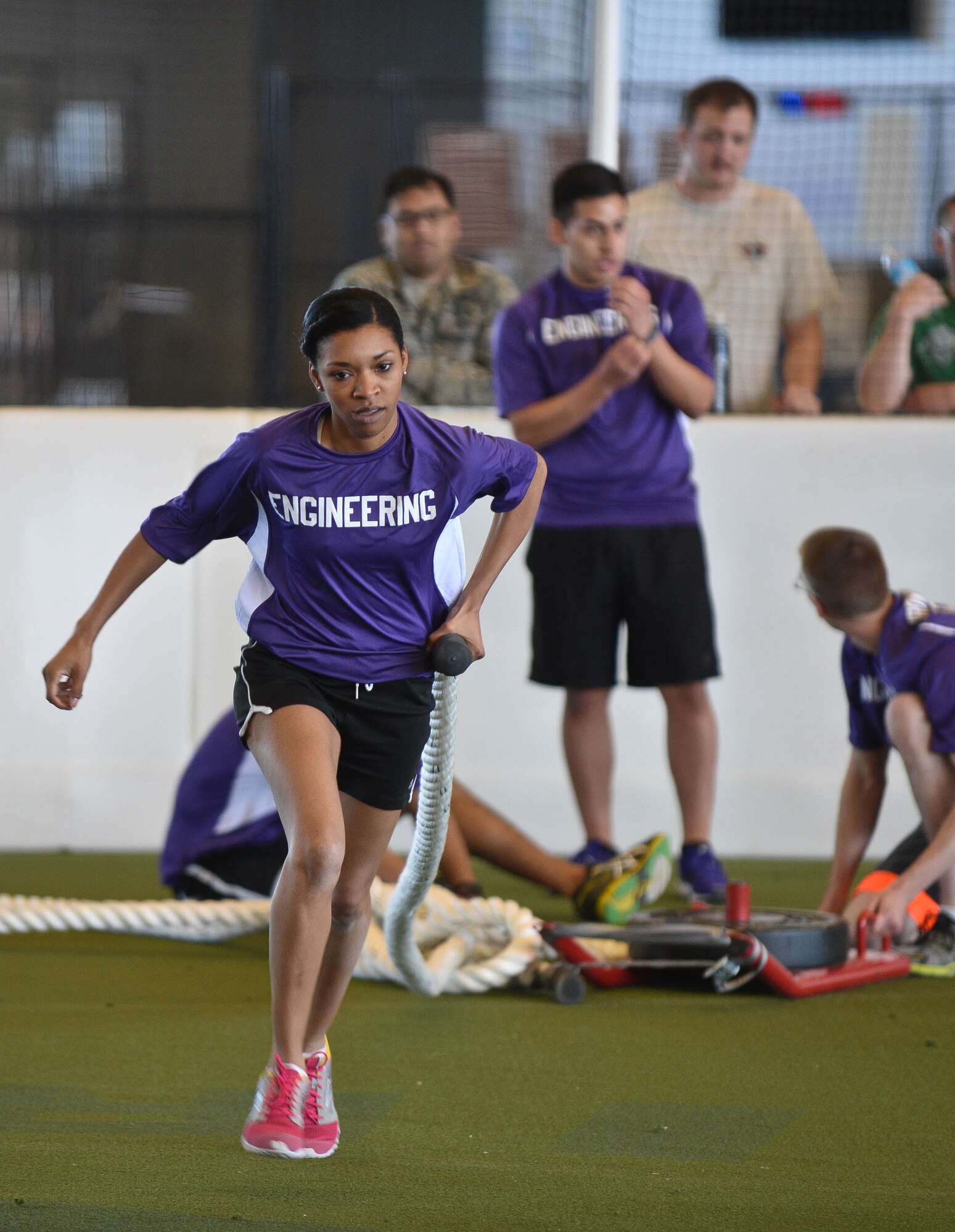 Staff Sgt. Lawanda Jenkins, 28th Civil Engineer Squadron engineering technician, performs a weighted rope pull during the Sexual Assault Prevention Combat Challenge in the Pride Hangar at Ellsworth Air Force Base, S.D., April 24, 2014.The event was done to promote physical fitness as well as raise sexual assault awareness and its effect on Airmen and their families. (U.S. Air Force photo by Senior Airman Zachary Hada/Released)