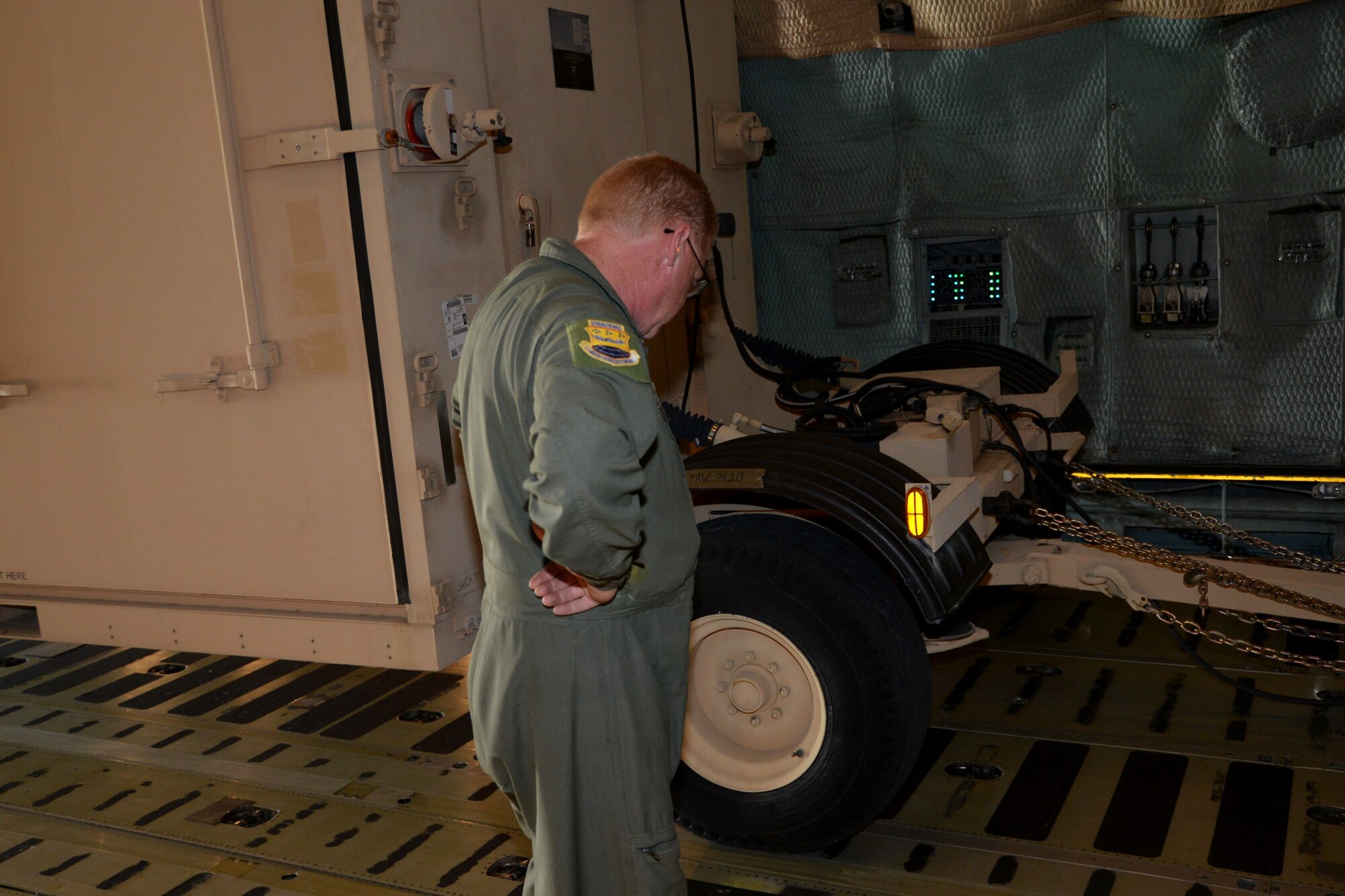Loadmaster Senior Master Sgt. Scott Lynch, 433rd Operations Group, Joint Base San Antonio-Lackland, Texas surveys cargo that has been tied down on a C-5A Galaxy aircraft prior to take-off to Naval Air Station, North Island, Calif, 24 April, 2014, for the Patriot Hook 2014 Exercise. (U.S. Air Force photo/Senior Master Sgt. Minnie Jones)
