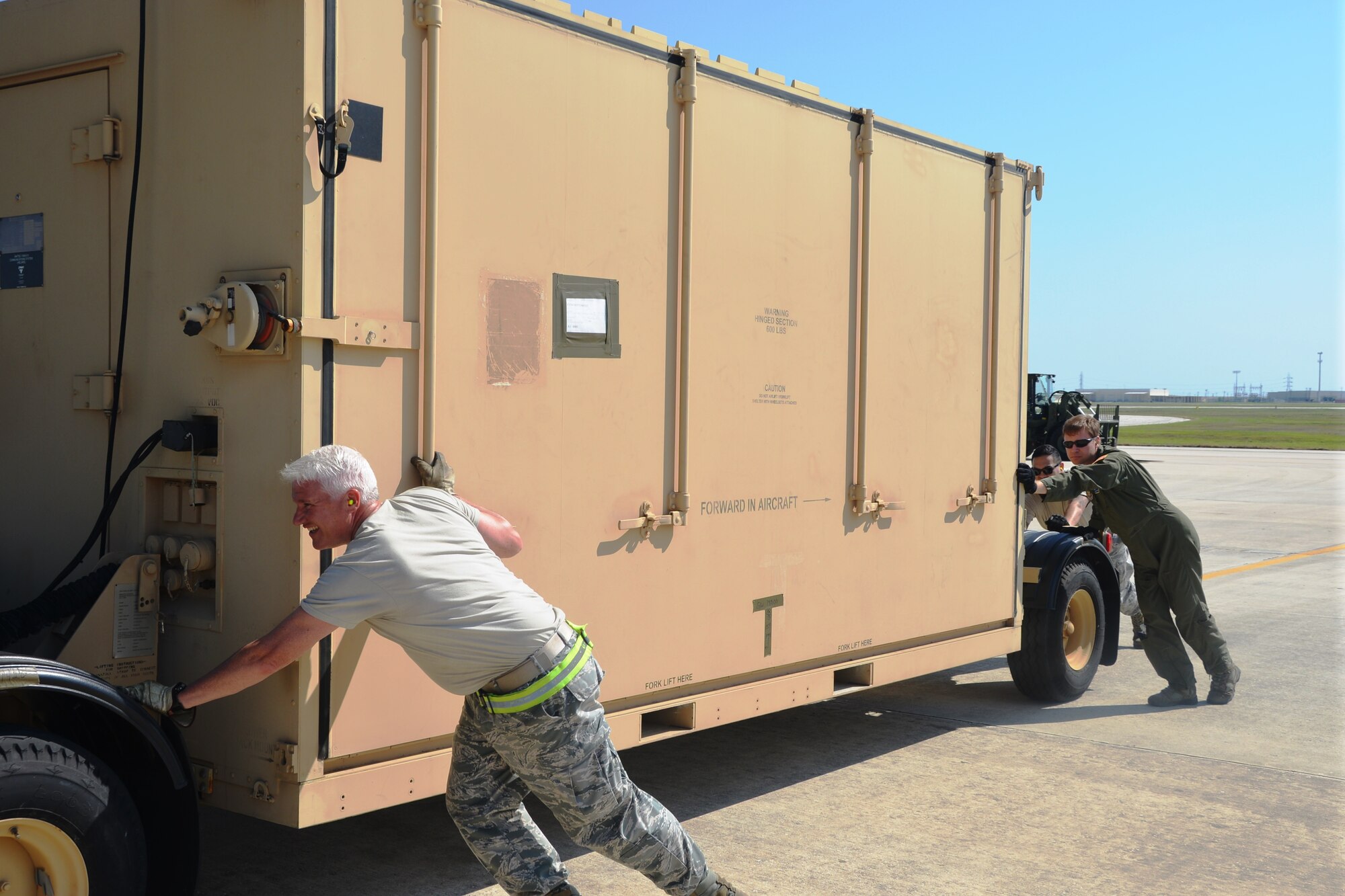 Master Sgt. Charlie Callahan, forefront, communication noncommissioned-officer-in-charge, 433rd Airlift Control Flight, Joint Base San Antonio-Lackland, Texas, positions a Hardside Expandable Light Air-Mobile Shelter in place before loading it on to a C-5A Galaxy aircraft. Twenty-three members from the 433rd Airlift Wing traveled to Naval Air Station, North Island, Calif. 23 April, 2014 to participate in the Air Force Reserve Command’s Patriot Hook Exercise at North Island, Calif. (U.S. Air Force photo/Senior Master Sgt. Minnie Jones)
