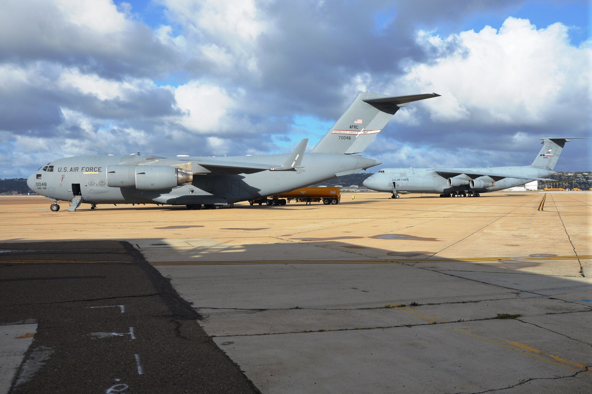 A C-17A Globemaster III (forefront) from the 445th Airlift Wing, Wright-Patterson Air Force Base, Ohio and a C-5A Galaxy from the 433rd Airlift Wing Joint Base San Antonio-Lackland sit on the flight line at the Naval Air Station, North Island, Calif., April 23-28, 2014.  Both aircraft participated in the Air Force Reserve Command’s Patriot Hook 2014 exercise. Patriot Hook is an annual Air Force Reserve Command sponsored exercise that integrates federal agencies with the military, focusing on making the most of command and support, training, integration and practicing mobilizations to disasters and emergencies. (U.S. Air Force photo/Senior Master Sgt. Minnie Jones)
