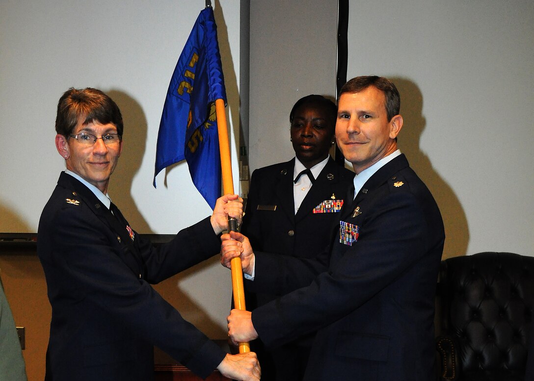 JOINT BASE CHARLESTON, S.C. – Col. Caroline Evernham, 315th Operations Group commander, presents Lt. Col. Stan Davis with command of the 317th Airlift Squadron April 28. Outgoing commander, Col. Brett Merritt is moving on to Dobbins Air Reserve Base, Georgia where he will be the new Vice Wing commander at the 94th Airlift Wing [home of the Hercules C-130H aircraft.] (Air Force Reserve Photo by Senior Airman Bobby Pilch) 