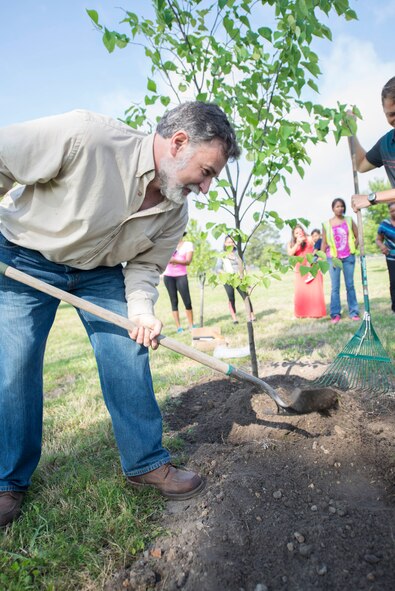 John Crain, 23d Civil Engineer Squadron base forester, puts the finishing touches on a newly planted Arbor Day tree at Moody Air Force Base, Ga., April 25, 2014. Crain also taught Moody’s Child Development Center children about trees found in Georgia, including its state tree, the live oak. (U.S. Air Force photo by Airman Dillian Bamman/Released)