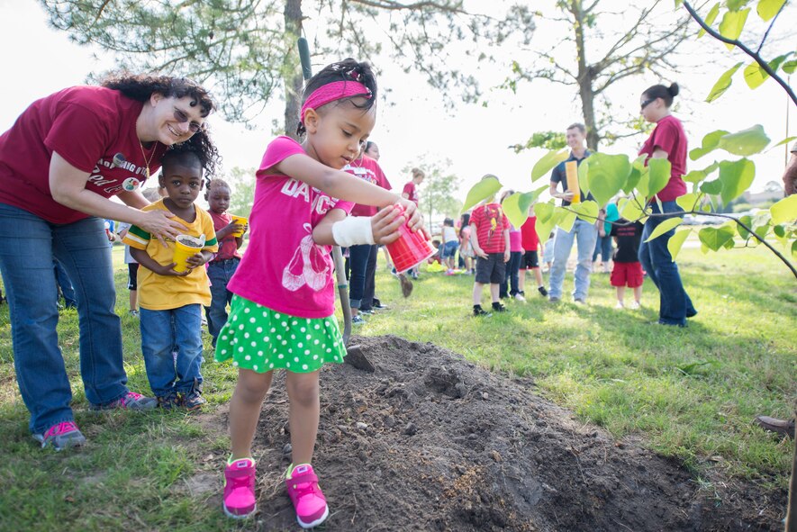 Children from the Child Development Center help plant a tree to celebrate Arbor Day and Earth Day at Moody Air Force Base, Ga., April 25, 2014. The tree-planting ceremony is an annual tradition for Tree City USA at Moody. (U.S. Air Force photo by Airman Dillian Bamman/Released)