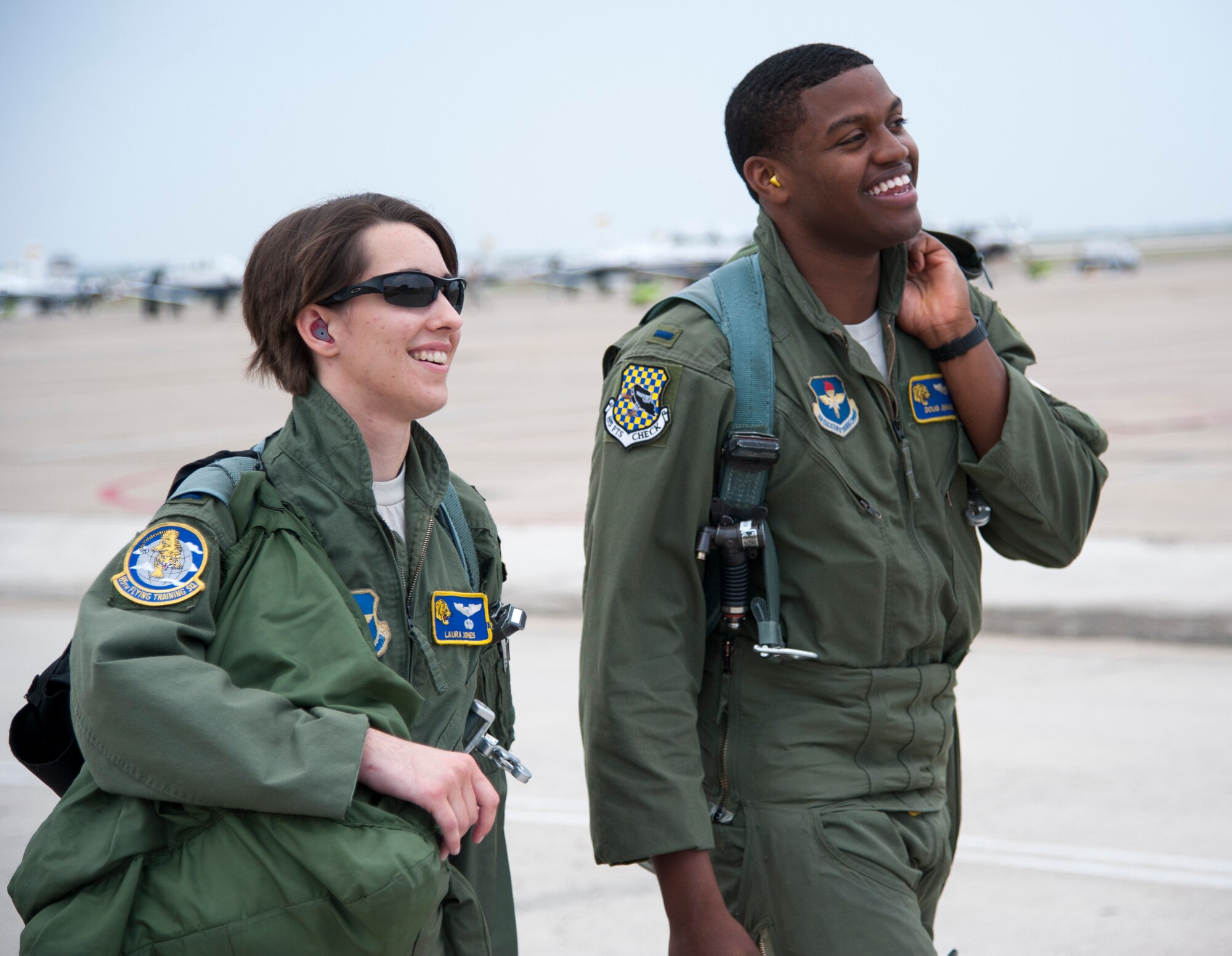 1st Lt. Laura Jones, 85th Flying Training Squadron T-6A Texan II instructor pilot, and 1st Lt. Doug Jenkins, 85th FTS T-6A Texan II instructor pilot, walk to their aircraft on Laughlin Air Force Base, Texas, April 21, 2014. The flight was Jones’ first flight back after an automobile accident in January. (U.S. Air Force photo/Airman 1st Class Jimmie D. Pike/Released)