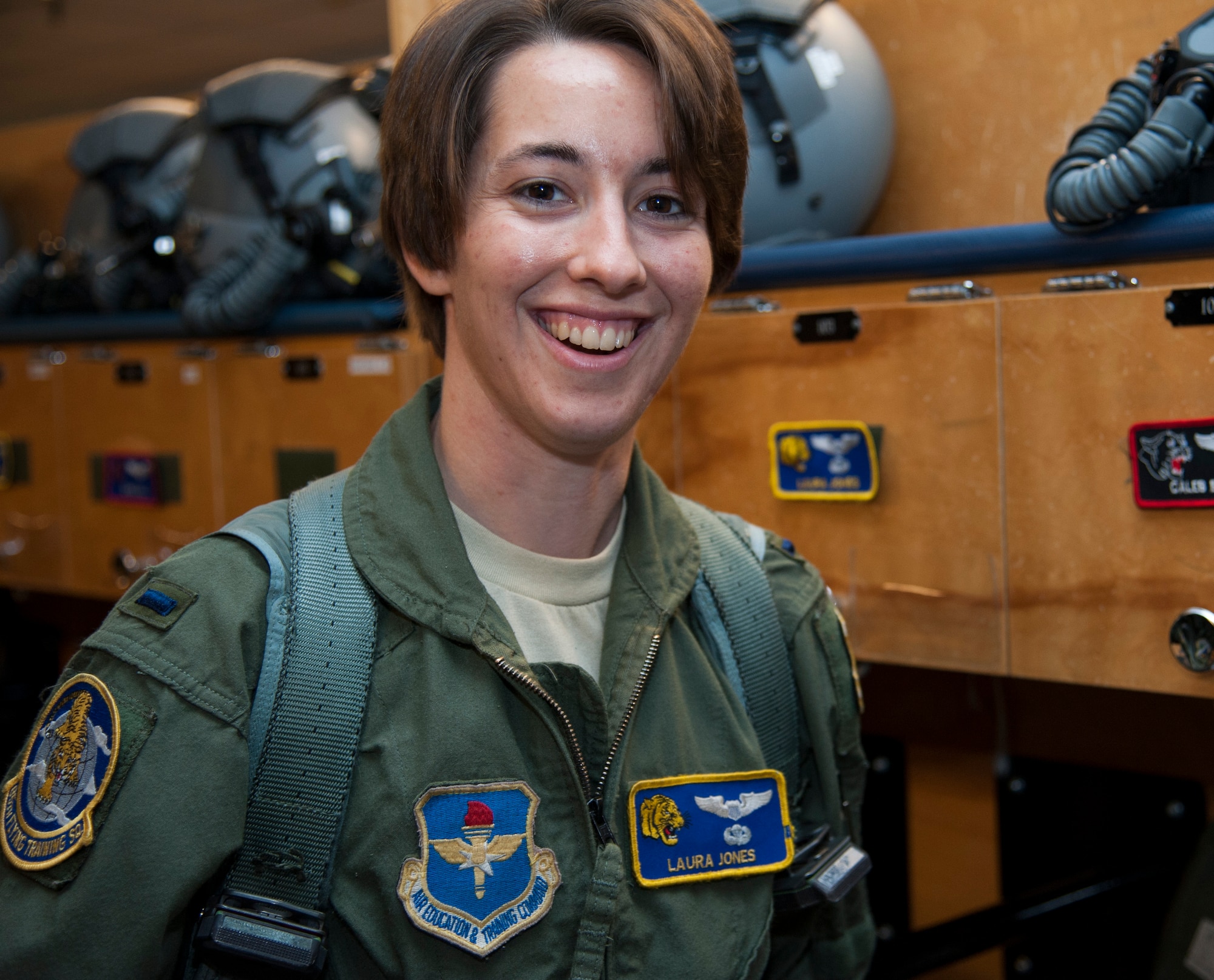 1st Lt. Laura Jones, 85th Flying Training Squadron T-6A Texan II instructor pilot, poses for a photo after harnessing up and getting ready to fly at Laughlin Air Force Base, Texas, April 21, 2014. Jones was involved in an automobile accident in January that kept her from flying for three months. (U.S. Air Force photo/Airman 1st Class Jimmie D. Pike/Released)