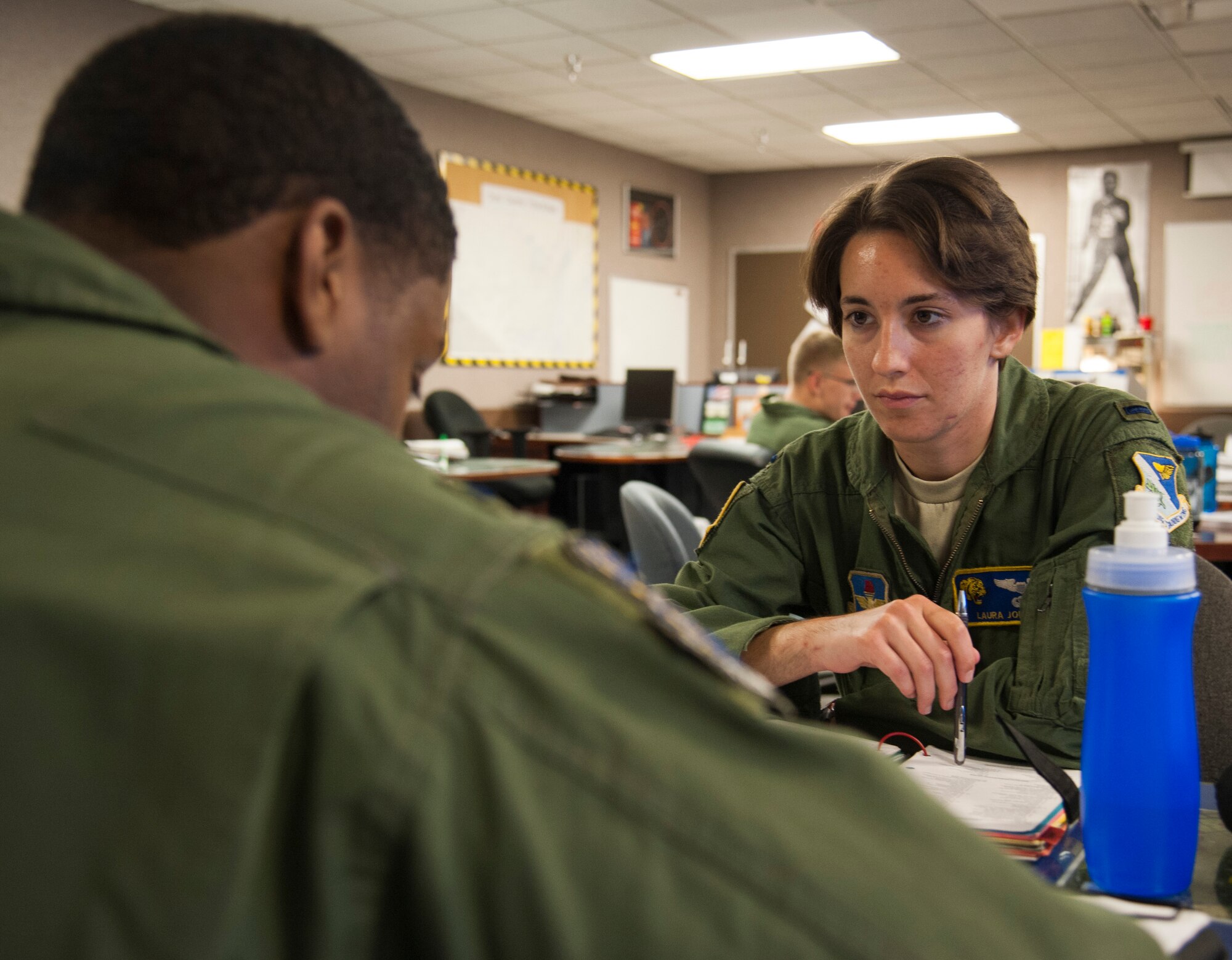 1st Lt. Laura Jones, 85th Flying Training Squadron T-6A Texan II instructor pilot, goes through a pre-flight briefing at Laughlin Air Force Base, Texas, April 21, 2014. During the briefing, plans were made for the flight to insure that Jones could take control of the Aircraft in the case of an emergency. (U.S. Air Force photo/Airman 1st Class Jimmie D. Pike/Released)