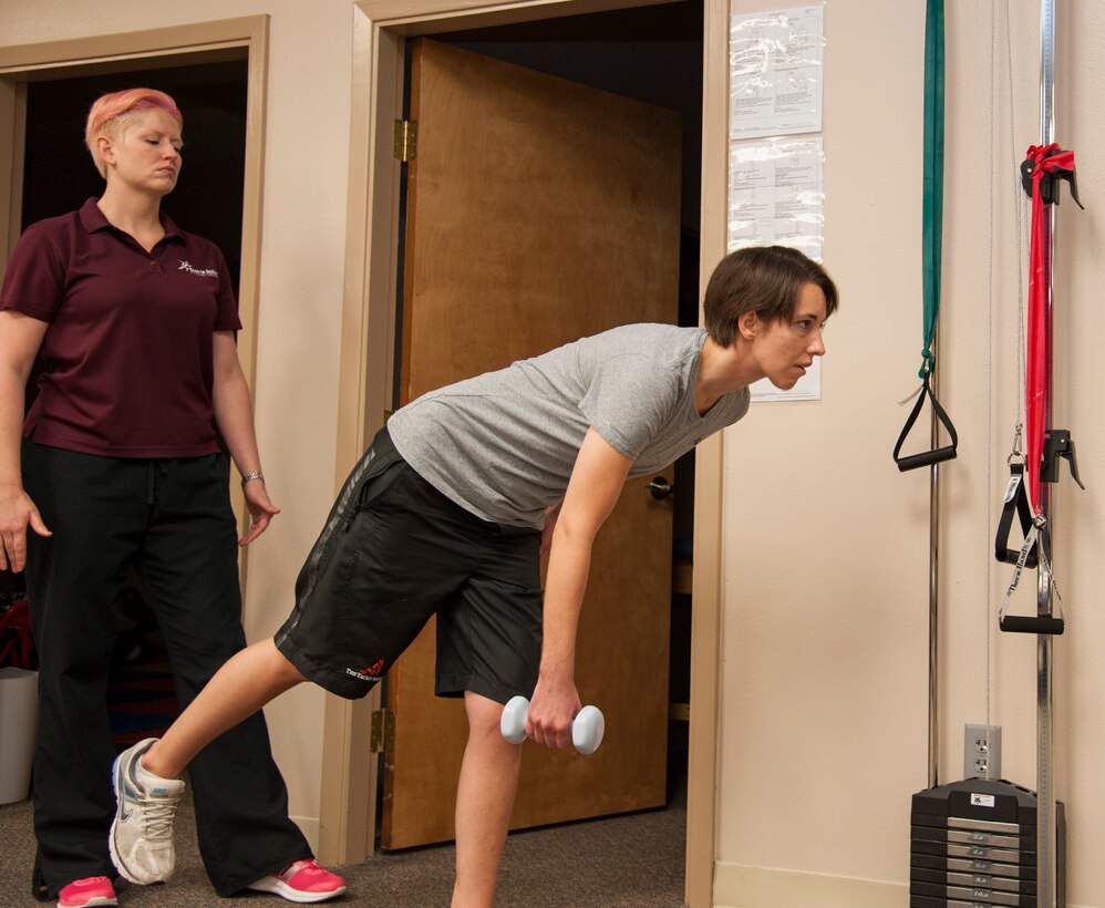1st Lt. Laura Jones, 85th Flying Training Squadron T-6A Texan II instructor pilot, performs single leg dead lifts at a local physical therapy clinic in Del Rio, Texas, April 21, 2014. The workout strengthens the hip stabilizers and helps develop balance. (U.S. Air Force photo/Airman 1st Class Jimmie D. Pike/Released)
