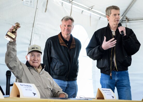 Robert Gilliland (seated), a retired test pilot for Lockheed Martin, holds up his “Bronze Skunk,” which was presented by LM employees, Steve Justice (right), Director for Advanced Systems Development, the Skunk Works’ Advanced Design Group, and Kent Burns (center), ADP program manager and former SR-71 reactivation chief engineer. Gilliland was at the helm of the first flight of an SR-71, which took place Dec. 22, 1964 from Air Force Plant 42 in Palmdale, Calif.The first SR-71 to enter service was delivered to the 4200th (later, 9th) Strategic Reconnaissance Wing at Beale Air Force Base, Calif., in January 1966. (U.S. Air Force photo by Rebecca Amber)