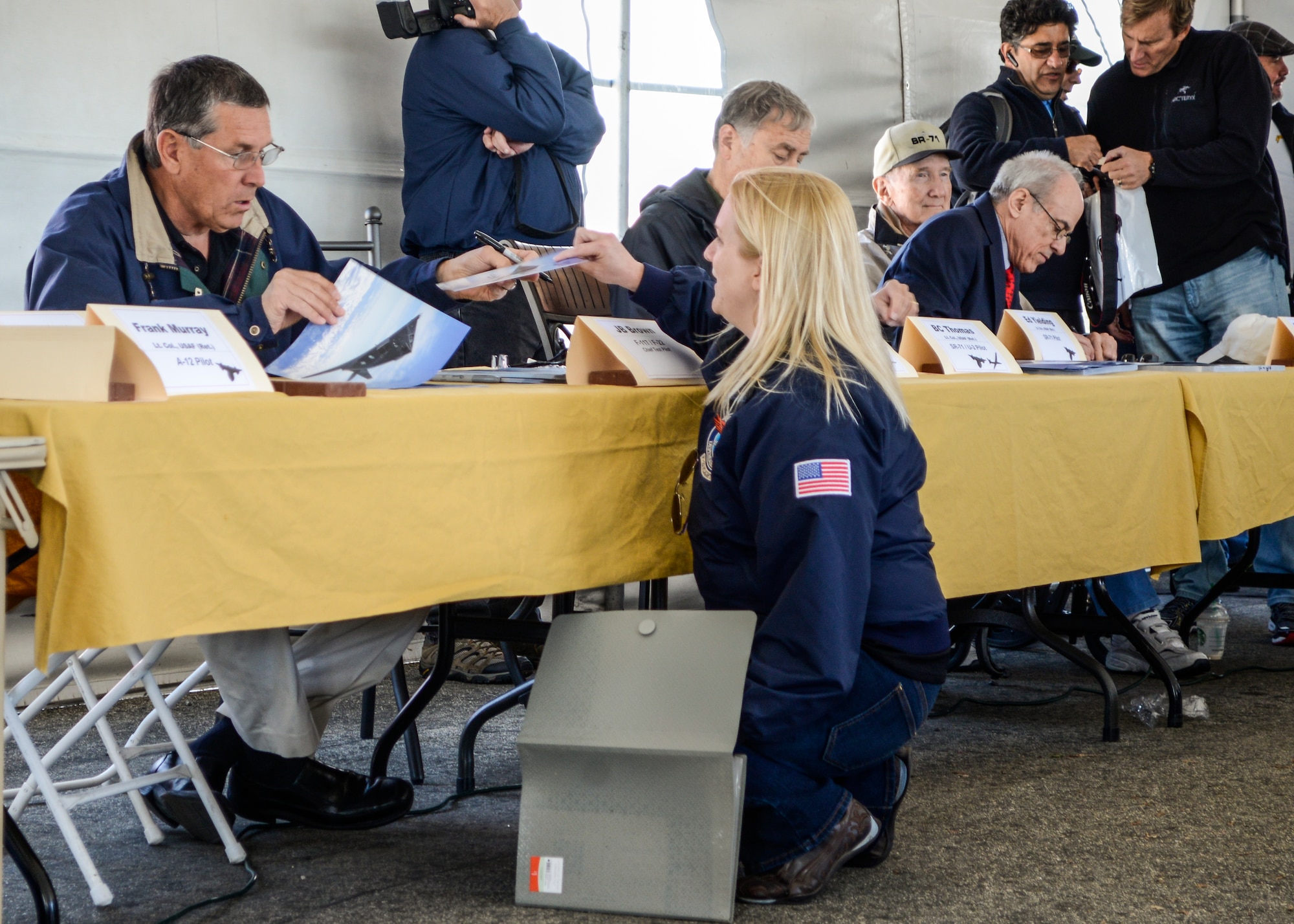 A visitor to the event has photographs signed by J.B. Brown, an F-117 and F-22 chief test pilot. (U.S. Air Force photo by Rebecca Amber)