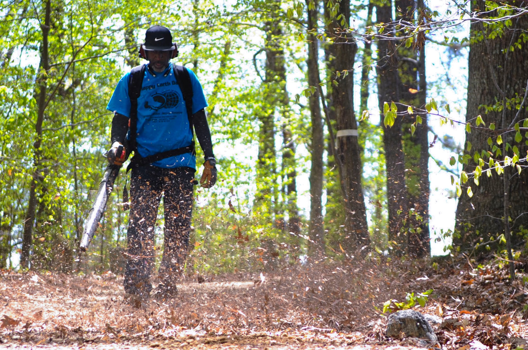 Don Johnson, 733rd Civil Engineer Division pollution prevention specialist, cleans up a nature trail during an Earth Week nature trail spring cleaning event at Fort Eustis, Va., April 21, 2014. Community members removed debris, added gravel and cleaned markers to enhance the 1.2 mile nature trail. (U.S. Air Force photo by Senior Airman Austin Harvill/Released) 
