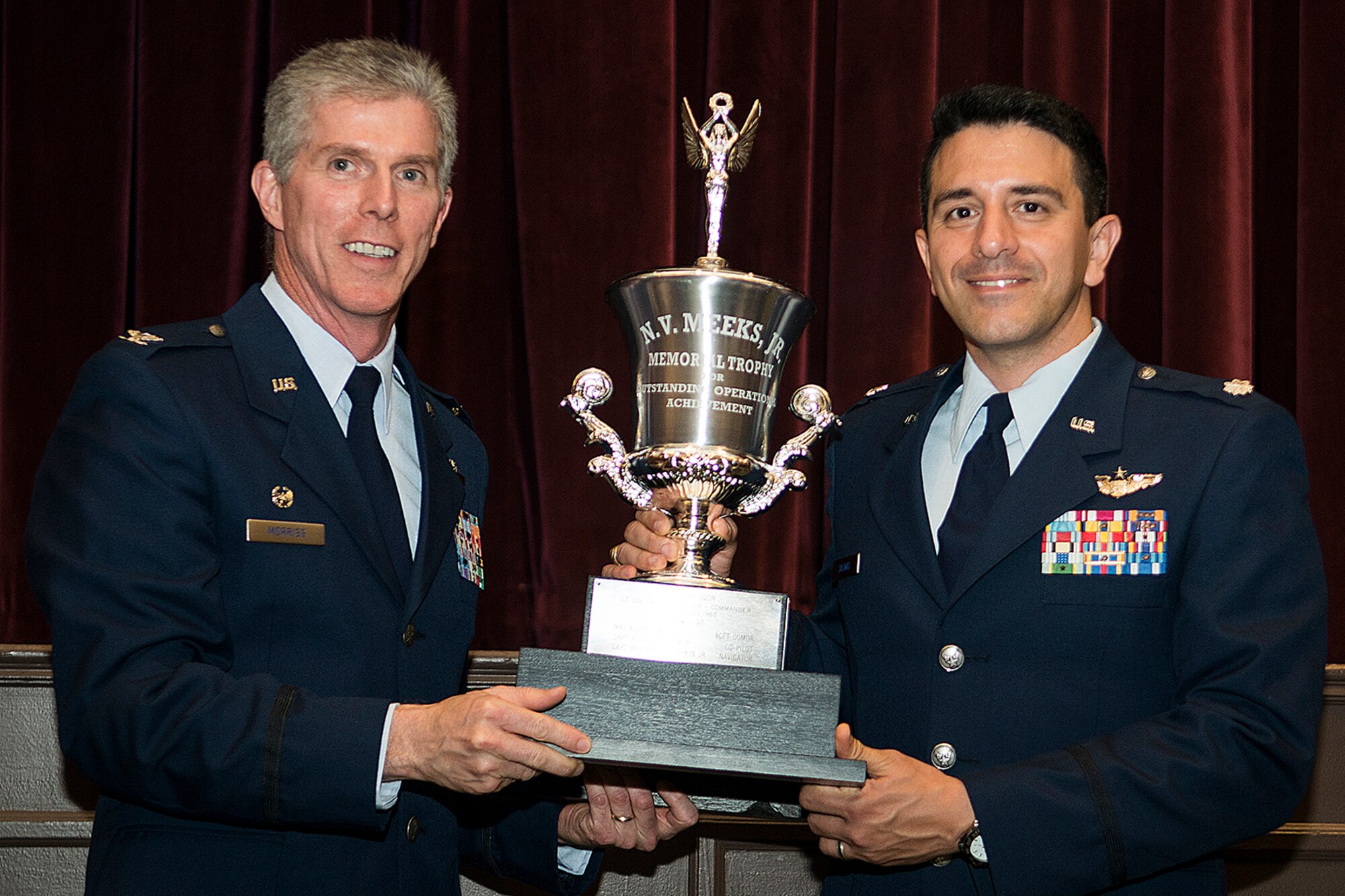 U.S. Air Force Col. James Morriss (left), 93rd Bomb Squadron commander, presents the N.V. Meeks, Jr. Memorial Trophy to Lt Col. Martin Salinas during the 307th Bomb Wing Combined Bomber/Tanker Reunion dinner, April 27, 2014, Bossier City, La. Salinas accepted the trophy on behalf of his crew who were selected as the best B-52 bomber aircrew following their recent graduation from the Formal Training Unit. (U.S. Air Force photo by Master Sgt. Greg Steele/Released)
