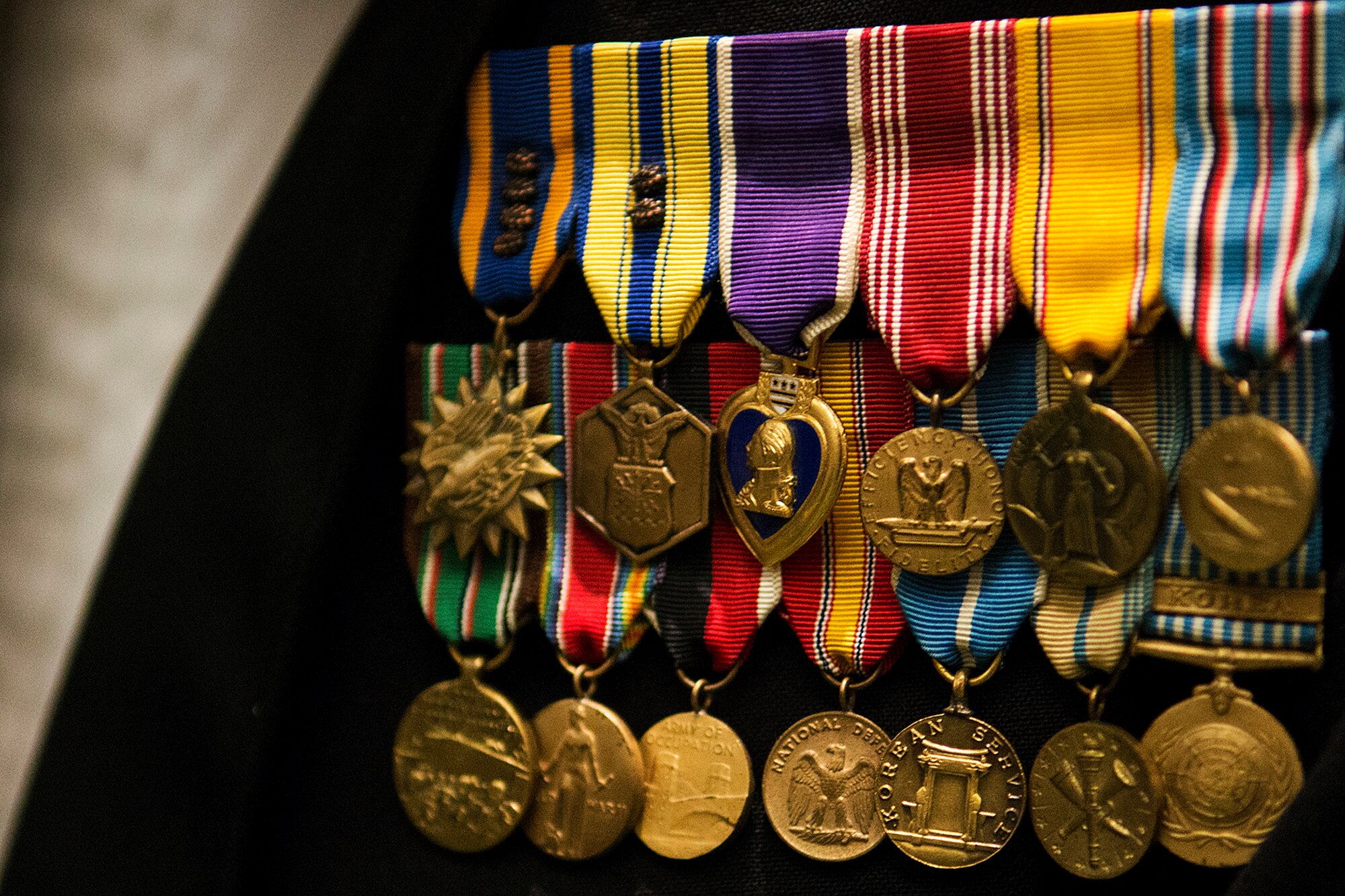 An assortment of military citations adorn the uniform worn by retired U.S. Air Force Lt. Col. Charles Screws during the 307th Bomb Wing Combined Bomber/Tanker Reunion dinner, April 26, 2014, Bossier City, La. One of the many medals awarded to Screws is the Purple Heart, which was awarded to him during World War II as a P-47 Thunderbolt pilot who was shot down by enemy ground fire, but with the help of the French Underground, was able to evade the German Army and escape into Spain. (U.S. Air Force photo by Master Sgt. Greg Steele/Released)