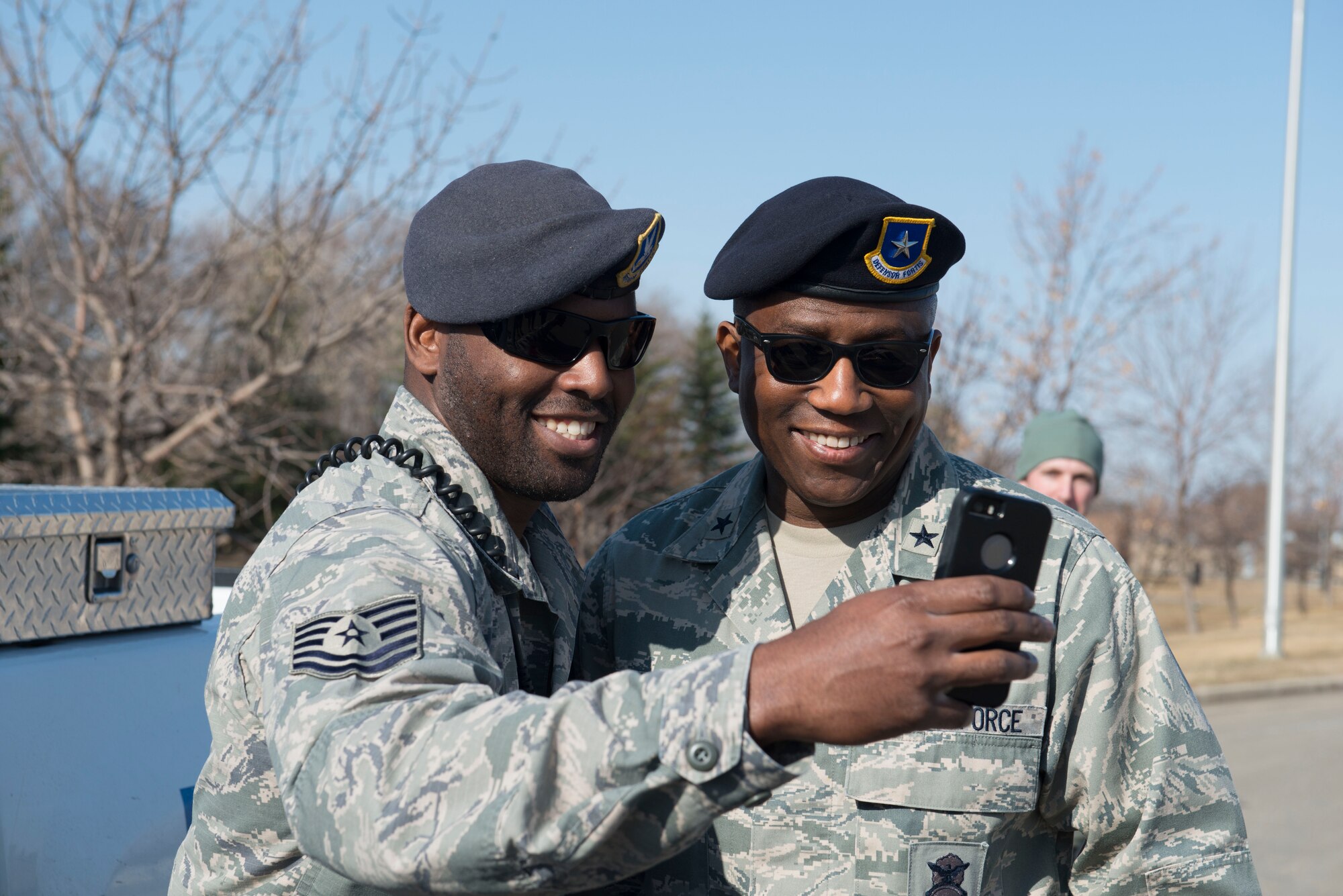 Brig. Gen. Allen J. Jamerson, director of security forces, deputy chief of staff for logistics, installations and mission support, Headquarters U.S. Air Force, takes a photo with Tech. Sgt. Theo Toliver, 5th Security Force Squadron military working dog handler, at Minot Air Force Base, N.D., April 21, 2014. Jamerson visited Airmen in the 91st Security Forces Group and 5th SFS to boost morale and discuss ideas to improve their career field. (U.S. Air Force photo/Airman 1st Class Sahara L. Fales)