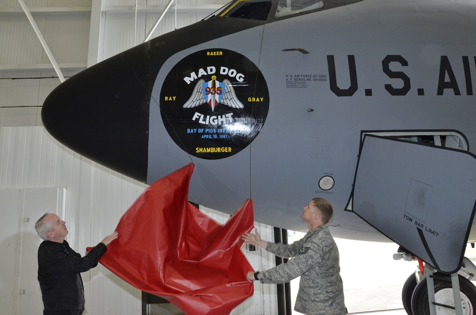 Retired members from the 117th Air Refueling Wing who participated in the Bay of Pigs invasion are honored during a nose art dedication for the Alabama Air National Guardsmen who were shot down and killed during the invasion. They are a few of the last surviving participants of the secret operation that cost the lives of Thomas Pete Ray, Riley Shamburger, Leo Baker and Wade Gray. (U.S. Air National Guard photo by Master Sgt. Ken Johnson/Released)