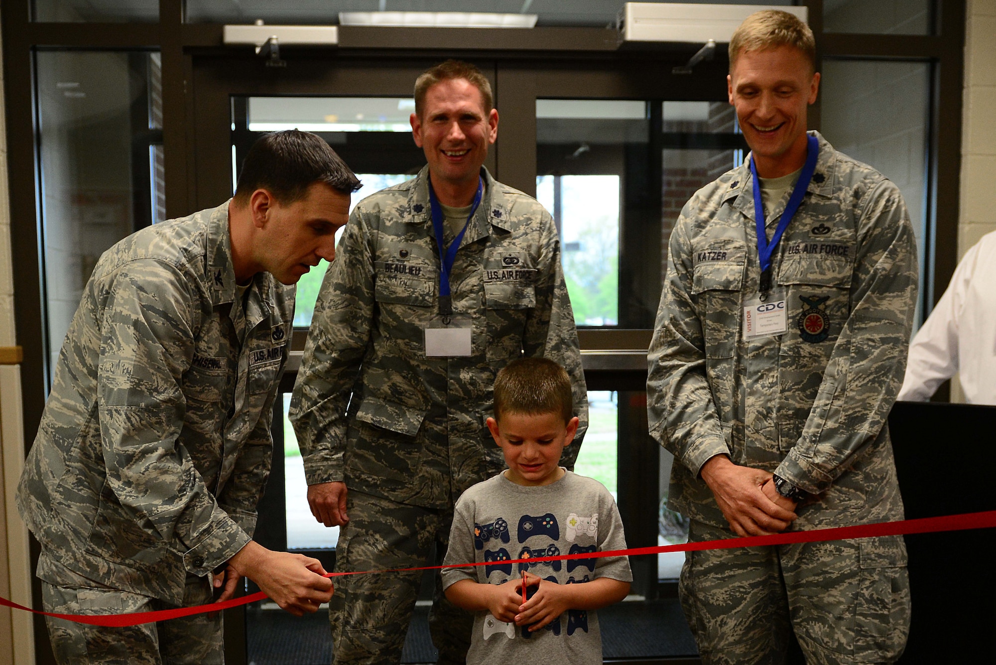 U.S. Air Force Airmen join 5-year-old Tyce Trandell in cutting the ribbon during the ceremony for the Child Development Center Annex at Langley Air Force Base, Va., April 28, 2014. Trandell is a member of the Gen. Russ CDC, and son of Tech. Sgt. Ryan Trandell, 633rd Communication Squadron noncommissioned officer in charge cable and antenna maintenance. The Trandells hail from Leesburg, Fla. (U.S. Air Force photo by Airman 1st Class Kimberly Nagle/Released)