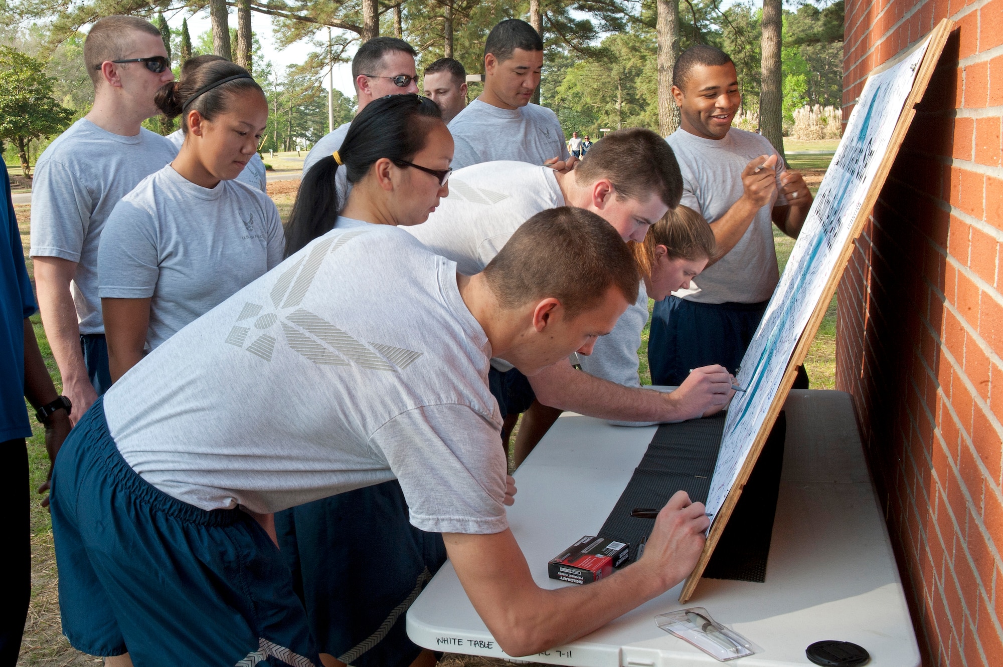 Members of the 4th Contracting Squadron pledge to combat sexual assault before participating in a 2-mile walk, April 25, 2014, at Seymour Johnson Air Force Base, N.C. The event was held during a Sexual Assault Prevention and Response Program stand-down day. (U.S. Air Force photo/Airman 1st Class Aaron J. Jenne)