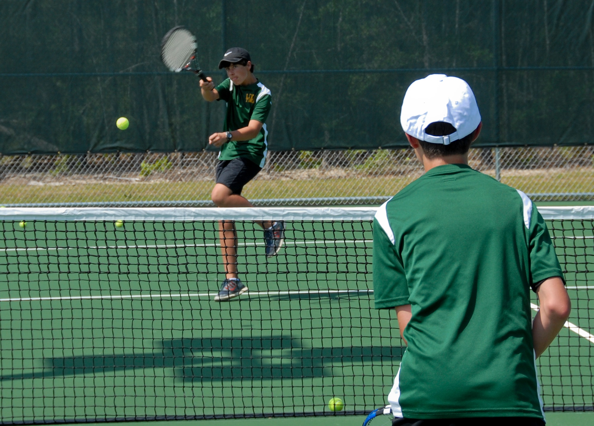 Lewis Middle School tennis teammates volley at the grand opening of eight new tennis courts April 25 at Eglin Air Force Base, Fla.  They were two of 75 participants in the “Thanking Our Troops through Tennis,” or T3, event at the new courts, located next to Eglin’s consignment shop.  Free tennis clinics were offered by former tennis professional players, coaches and certified teaching professionals.  (U.S. Air Force photo/Kevin Gaddie)