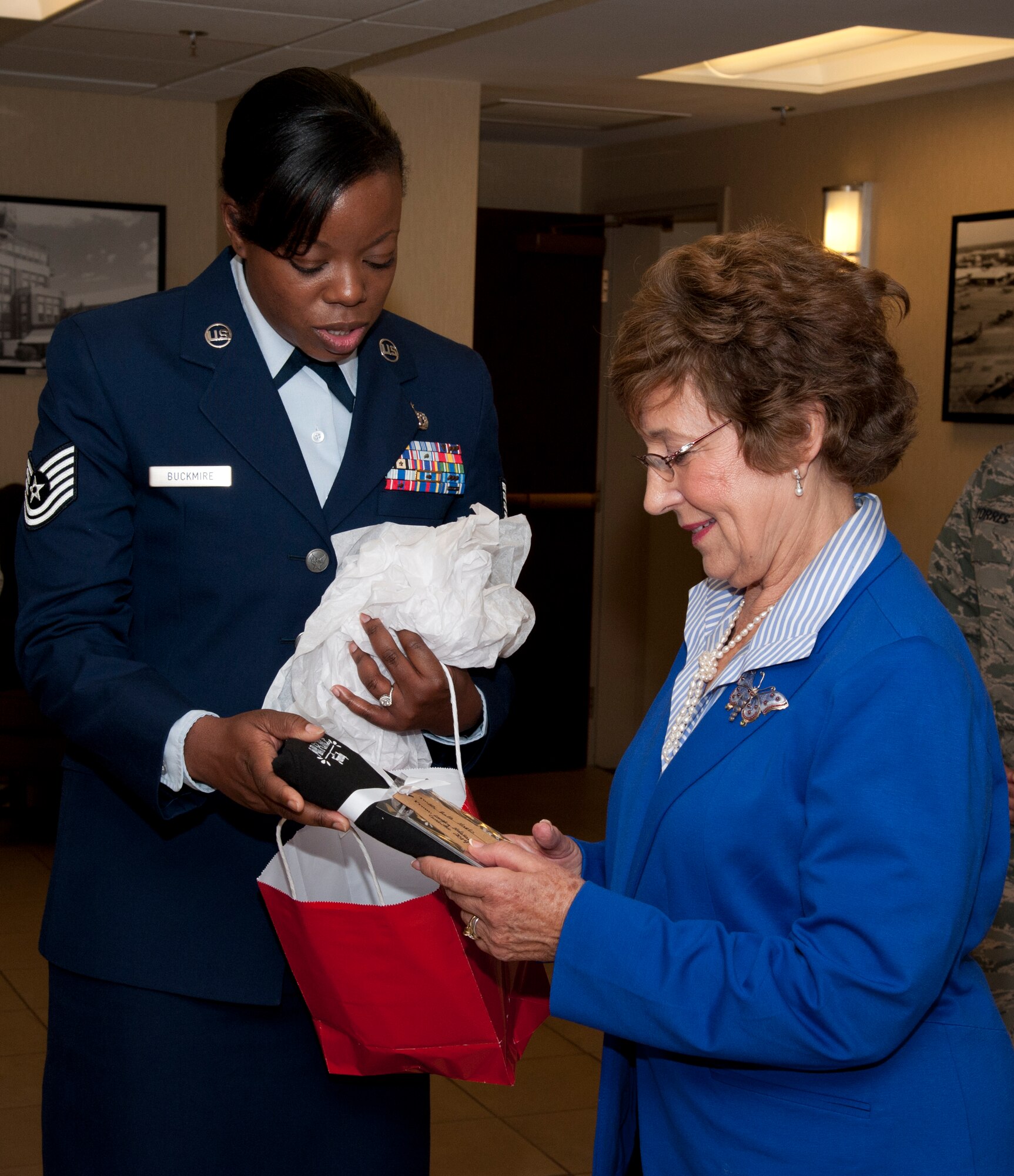 U.S. Air Force Tech. Sgt. Jennifer Buckmire, Command Support Staff noncommissioned officer in charge, presents a “thank you” gift to Ruth Kapp Hartz April 28, 2014 at Langley Air Force Base. Hartz was the guest speaker at a Days of Remembrance ceremony and one of the “hidden children” who lived through the Holocaust in southern France. (U.S. Air Force photo by Melissa Walther/Released)