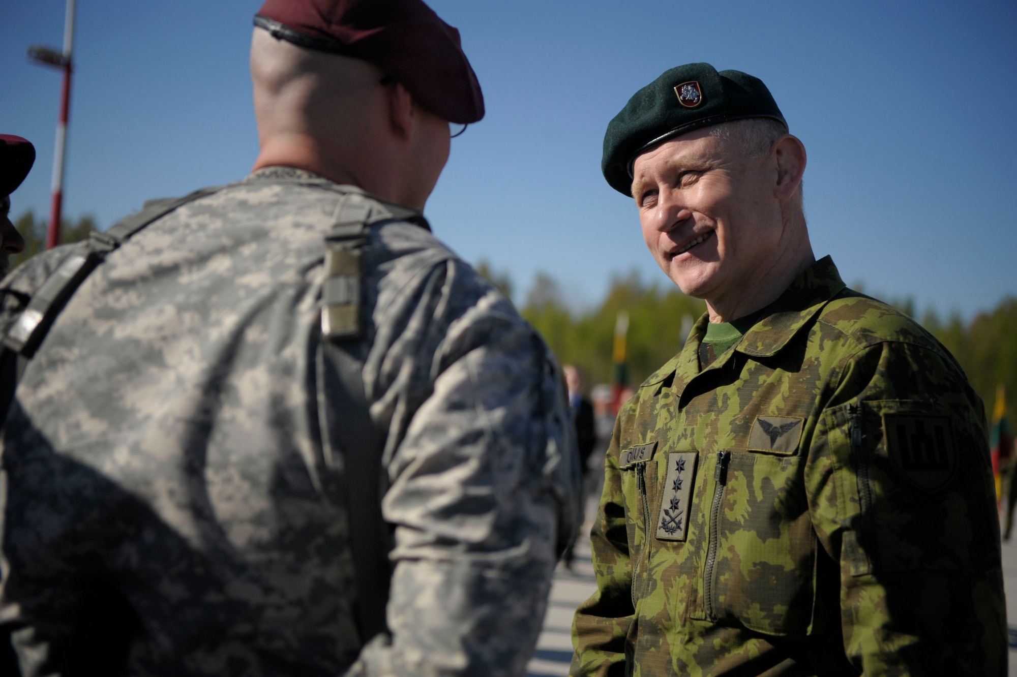 Maj. Gen. Almantas Leika, Lithuanian Land Force and Exercise director, greets Soldiers from the 173rd Infantry Brigade Combat Team (Airborne) at Siauliai air base, Lithuania, April 26, 2014. Airmen from the 37th AS flew from Ramstein Air Base, Germany to Aviano to pick up 150 paratroopers and then transported them to Lithuania. Upon their arrival Lithuanian President, Dalia Grybauskaite, also greeted the Soldiers. (U.S. Air Force photo/Staff Sgt. Sara Keller)
