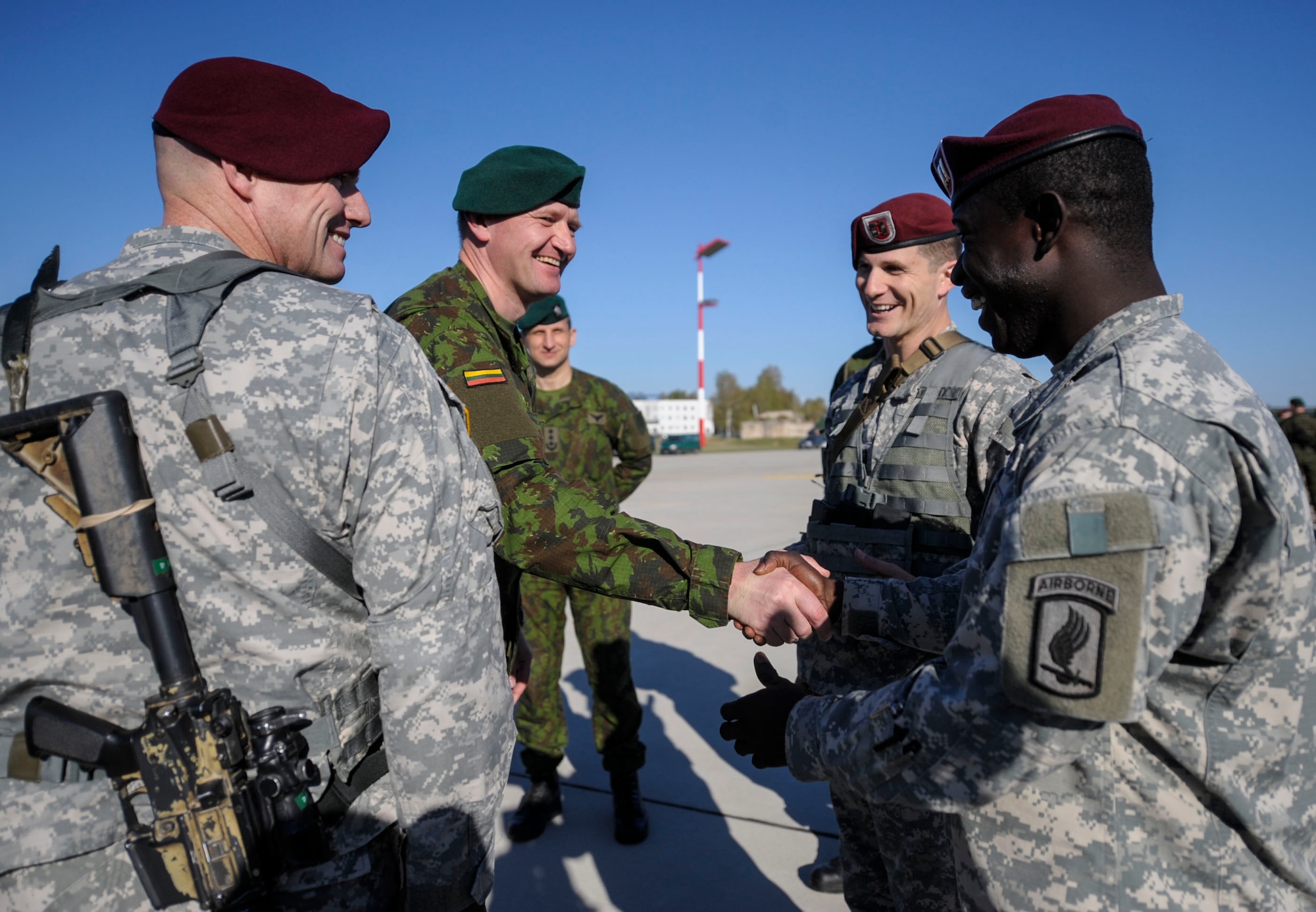 Maj. Gen. Almantas Leika, Lithuanian Land Force and Exercise director, greets Soldiers from the 173rd Infantry Brigade Combat Team (Airborne) at Siauliai air base, Lithuania, April 26, 2014. Airmen from the 37th AS flew from Ramstein Air Base, Germany to Aviano to pick up 150 paratroopers and then transported them to Lithuania. Upon their arrival Lithuanian President, Dalia Grybauskaite, also greeted the Soldiers. (U.S. Air Force photo/Staff Sgt. Sara Keller)