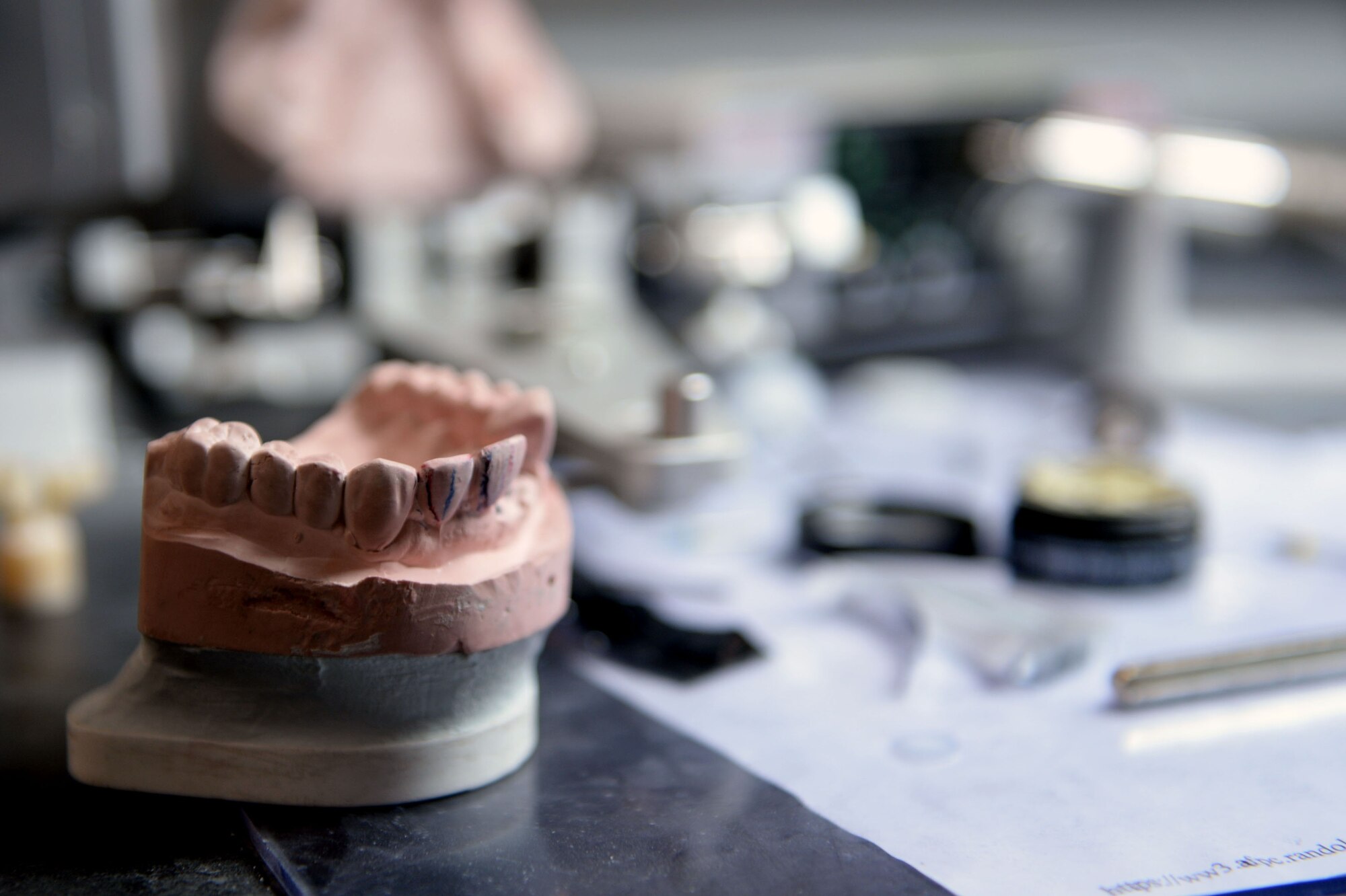 A dental mold stands on the work area of a dental laboratory technician at Spangdahlem Air Base, Germany, April 23, 2014. The mold was used to match a crown fitting for a patient. (U.S. Air Force photo by Senior Airman Alexis Siekert/Released)