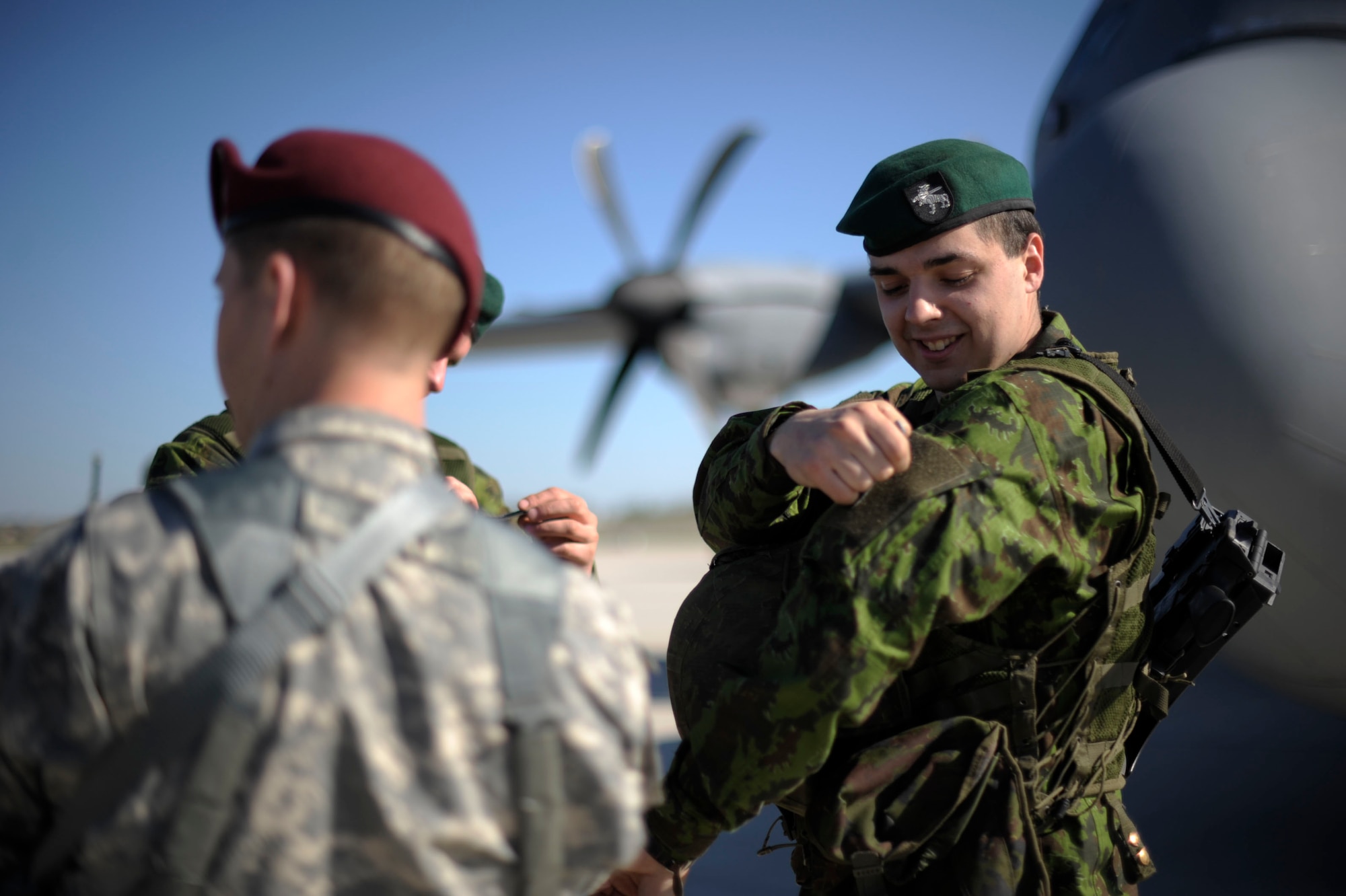 A paratrooper from the 173rd Infantry Brigade Combat Team (Airborne) trades unit patches with a soldier from the Lithuanian Army at Siauliai air base, Lithuania, April 26, 2014. Airmen from the 37th Airlift Squadron transported 150 paratroopers from Aviano Air Base, Italy to Lithuania at the request of the host nations in the region and to further demonstrate U.S. commitment to NATO. (U.S. Air Force photo/Staff Sgt. Sara Keller)