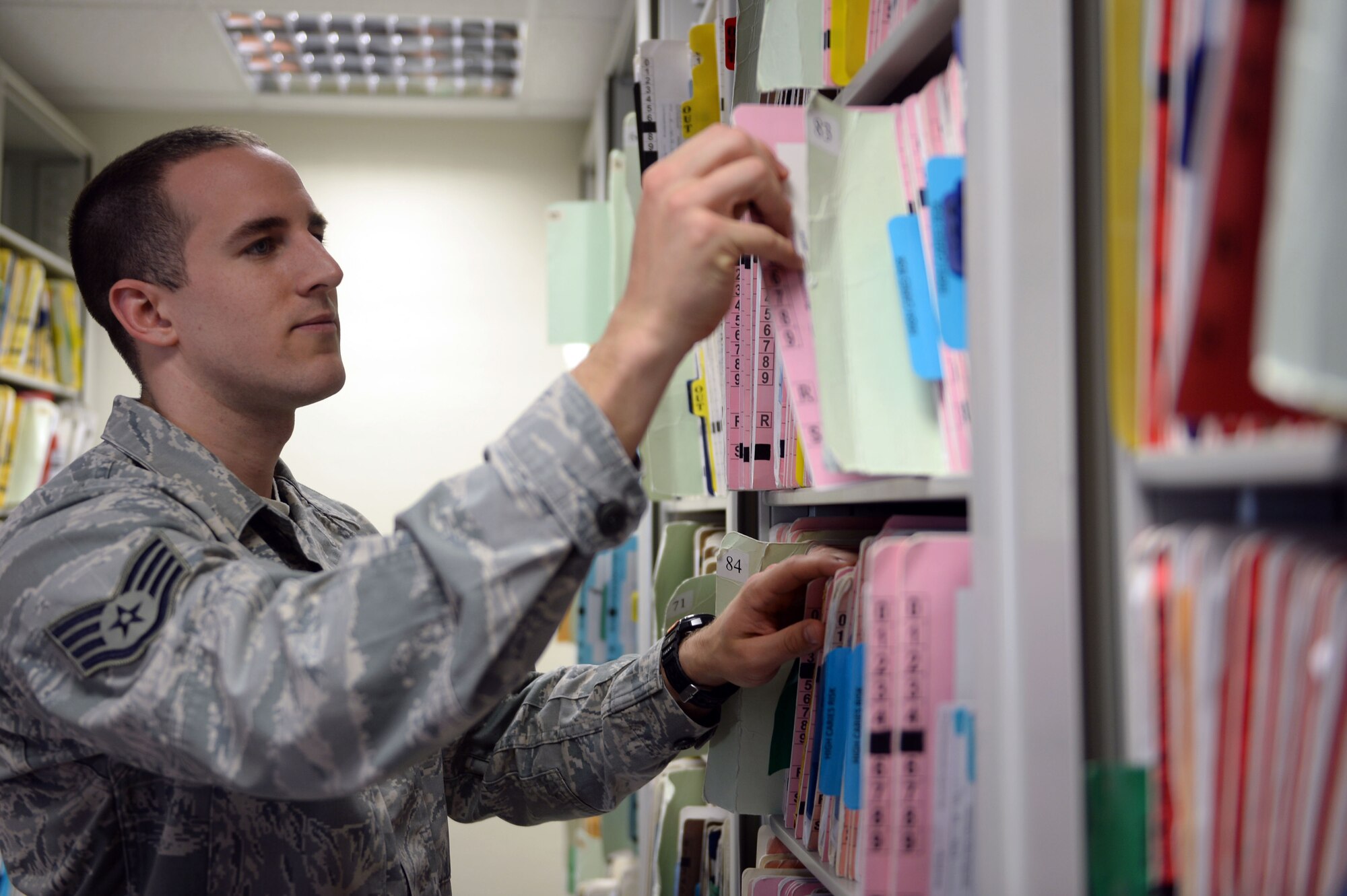 U.S. Air Force Staff Sgt. Joshua Diel, a 52nd Dental Squadron dental assistant, handles patient records on Spangdahlem Air Base, Germany, April 23, 2014. Spangdahlem’s dental clinic provides dental care to Spangdahlem and geographically separated units. (U.S. Air Force photo by Senior Airman Alexis Siekert/Released)