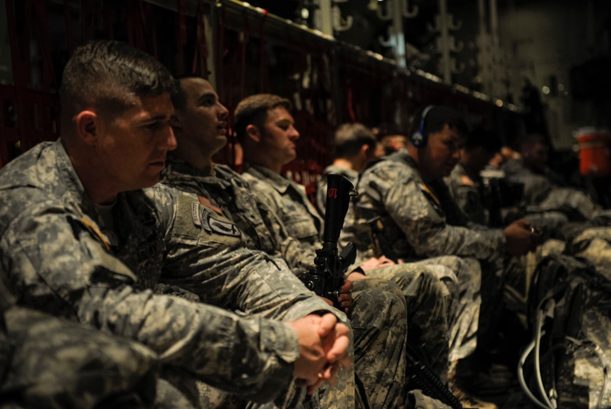 Paratroopers from the 173rd Infantry Brigade Combat Team (Airborne) settle in a C-130J Super Hercules from the 37th Airlift Squadron before flying to Lithuania, April 26, 2014. Airmen from the 37th AS flew from Ramstein Air Base, Germany to Aviano to pick up 150 paratroopers and then transported them to Siauliai air base, Lithuania. Upon their arrival, Lithuanian President, Dalia Grybauskaite, greeted the soldiers. (U.S. Air Force photo/Staff Sgt. Sara Keller)