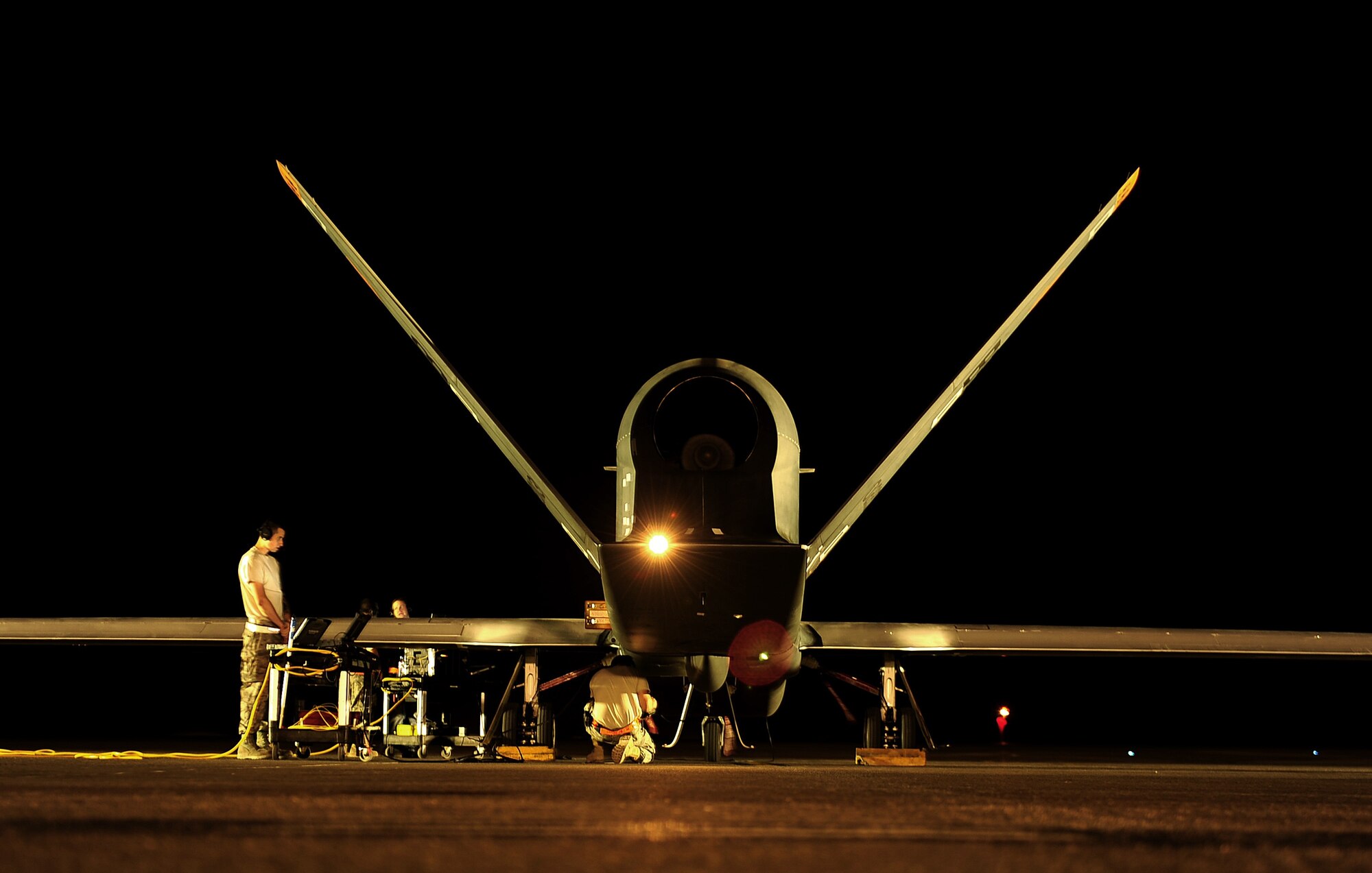 An RQ-4 Global Hawk undergoes pre-flight checks from maintenance technicians before a mission while deployed at an air base in Southwest Asia. Equipped on a block 40 Global Hawk, the Air Force completed the first Maritime Modes program risk reduction flight April 14, 2014. The system is designed to provide intelligence, surveillance and reconnaissance information on vessels traveling on the water's surface. (U.S. Air Force photo/Staff Sgt. Andy M. Kin) 

