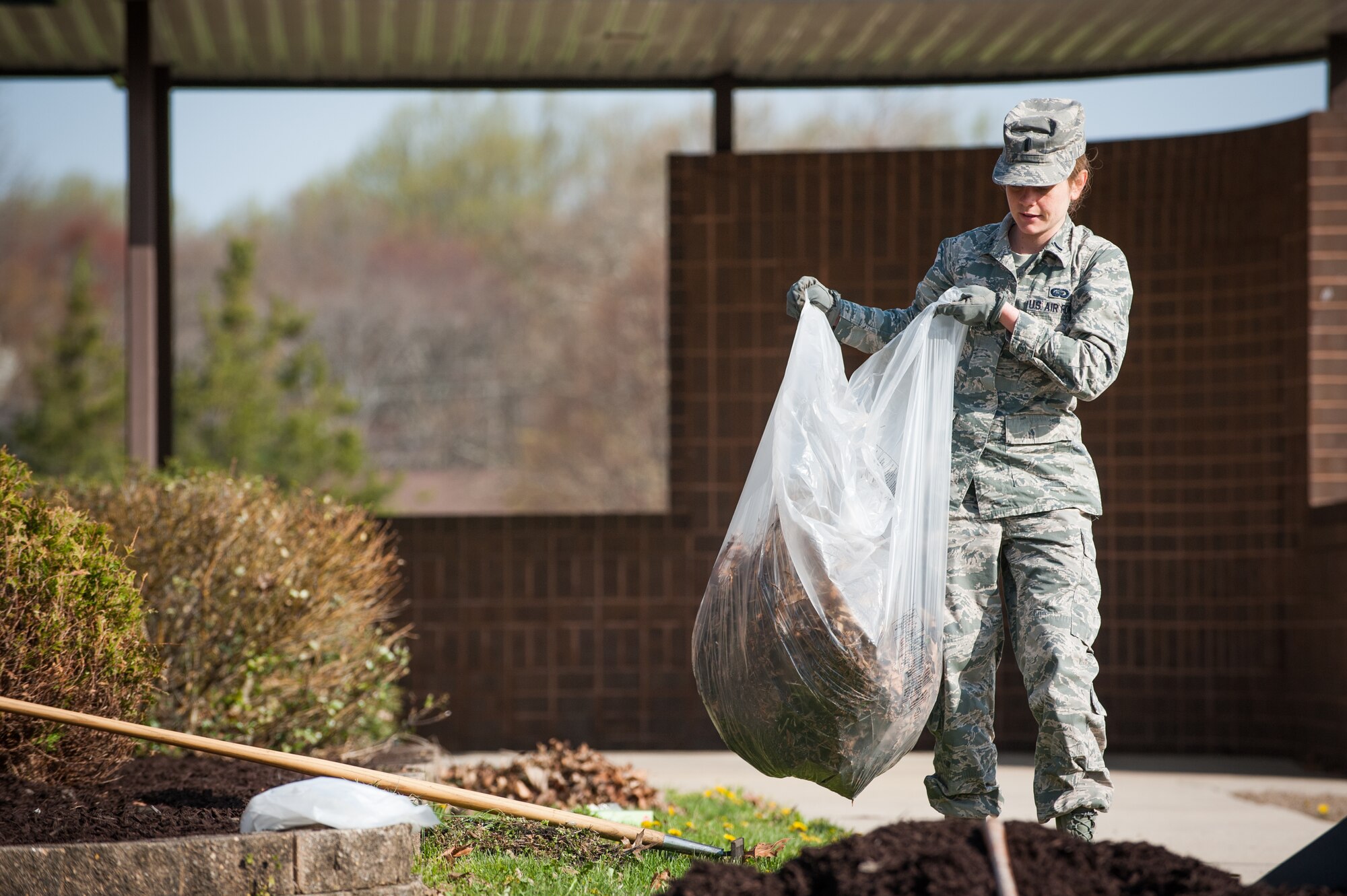 1st. Lt. Lauren Adams, 87th Force Support Squadron resource management, prepares the garden area at building 2905 during Joint Base Beautification Day Apr. 22, 2014, on Joint Base McGuire-Dix-Lakehurst, N.J. The spring clean up gave units the opportunity to show pride in JB MDL appearance. Adams hails from Gulfport, Miss. (U.S. Air Force photo by Russ Meseroll/Released)