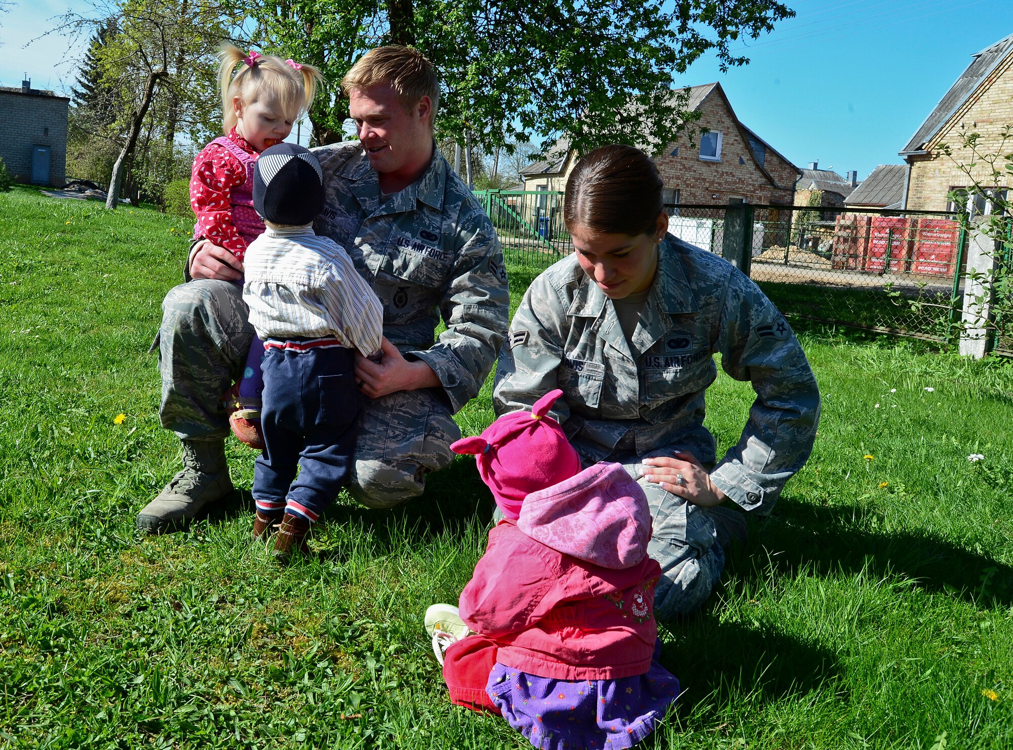 Airmen 1st Class Kolby and Priscilla Davis, 48th Air Expeditionary Group response force members, play with children at the Šiauliai City Baby’s Orphanage in Lithuania, April 27, 2014. Airmen from the 48th AEG visited the orphanage to give them an industrial washer and dryer. Airmen raised money throughout the four month Baltic Air Policing mission to buy the washer and dryer to give to the orphanage.  The Airmen also visited the orphanage multiple times during their deployment to bring gifts and candy and play with the young children. (U.S. Air Force photo by Airman 1st Class Dana J. Butler/Released)
