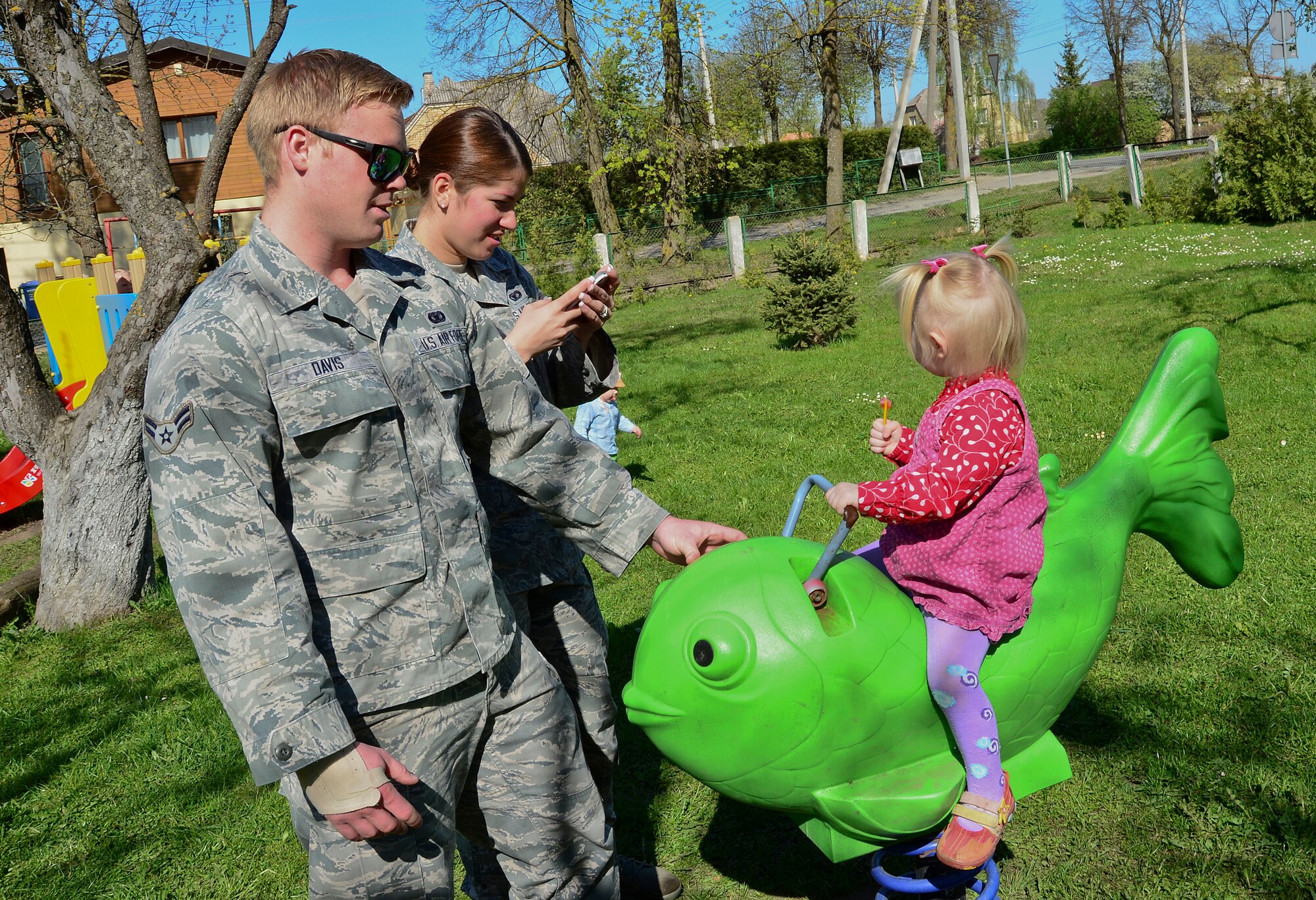 Airmen 1st Class Kolby and Priscilla Davis, 48th Air Expeditionary Group response force members, play with children at the Šiauliai City Baby’s Orphanage in Lithuania, April 27, 2014. Airmen from the 48th AEG visited the orphanage to give them an industrial washer and dryer. Airmen raised money throughout the four month Baltic Air Policing mission to buy the washer and dryer for the orphanage. The Airmen also visited the orphanage multiple times during their deployment. (U.S. Air Force photo by Airman 1st Class Dana J. Butler/Released)