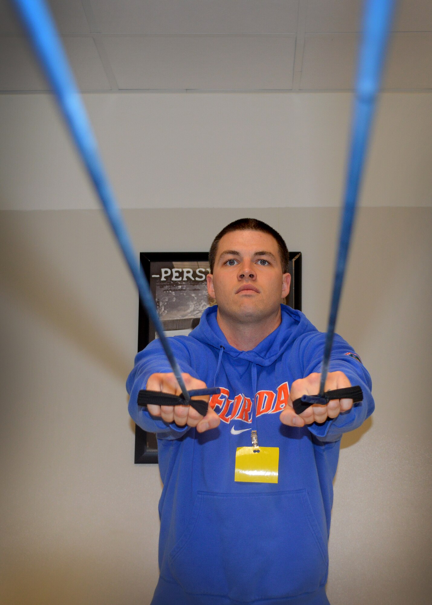 Senior Airman Joshua Stevenson, 31st Maintenance Group, uses a band to strengthen his scapular muscles during physical therapy at the Health and Wellness Center, April 21, 2014, at Aviano Air Base, Italy.  The HAWC offers physical therapy as a tool to help Airmen on their road to recovery after physical injuries.  (U.S. Air Force photo/Airman First Class Abbey Whittaker)